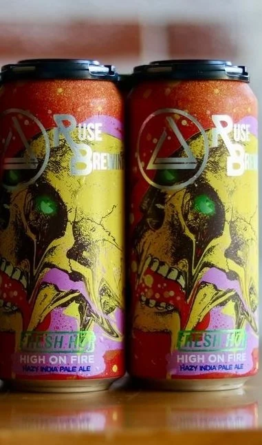 Two cans of Ruse Brewing's "High on Fire" hazy India Pale Ale with a colorful, abstract design on the label.