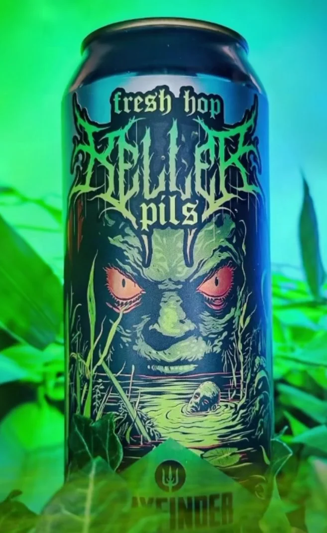 Fresh Hop Pils beer can with monster illustration, surrounded by green leaves.