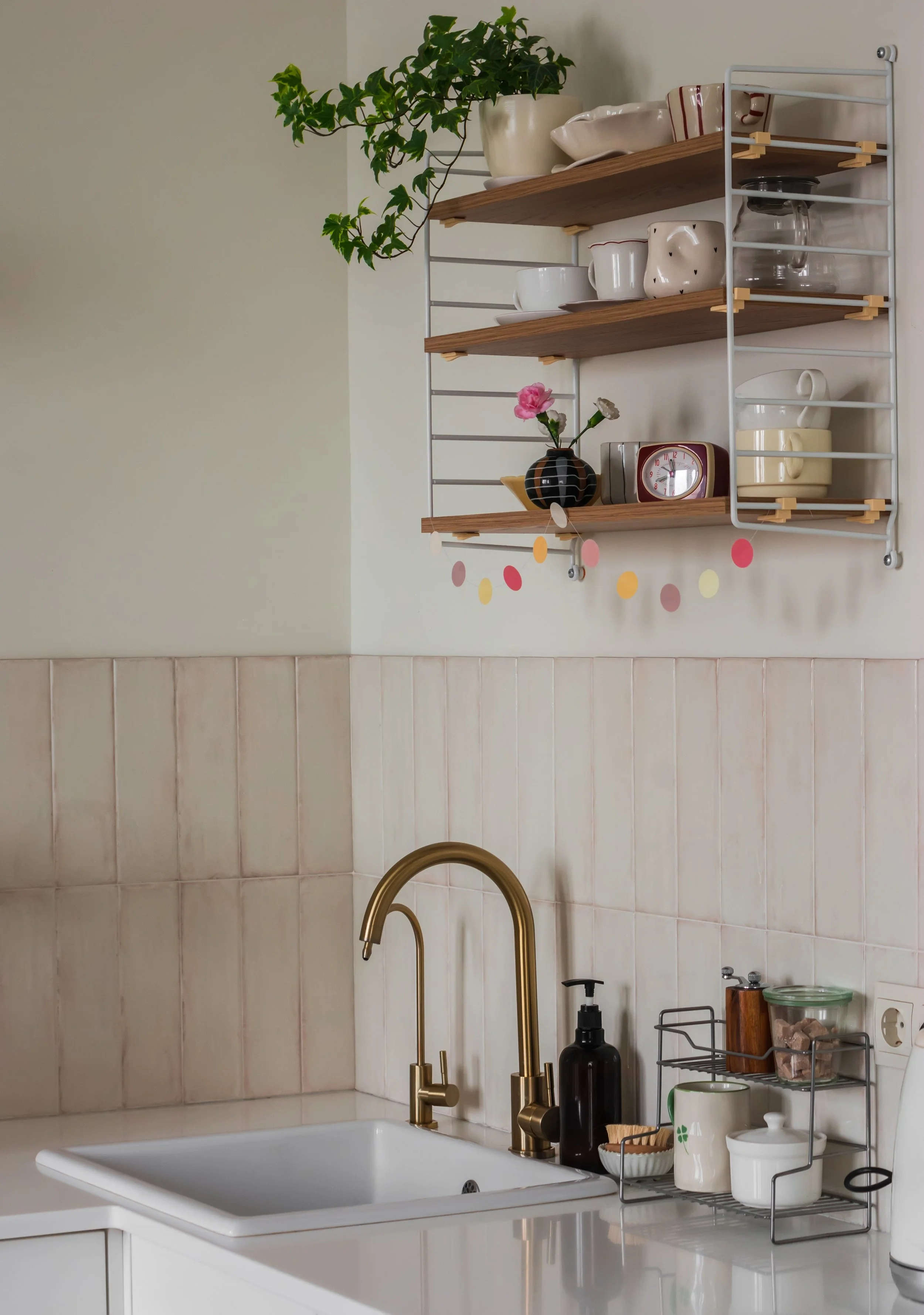 Bright clean kitchen with gold faucet and warm neutral tones, representing Pura Vida's professional cleaning services in Sudbury