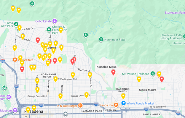 Map of a city showing various locations marked with color-coded pins, including parks, restaurants, stores, and trails in the surrounding area.