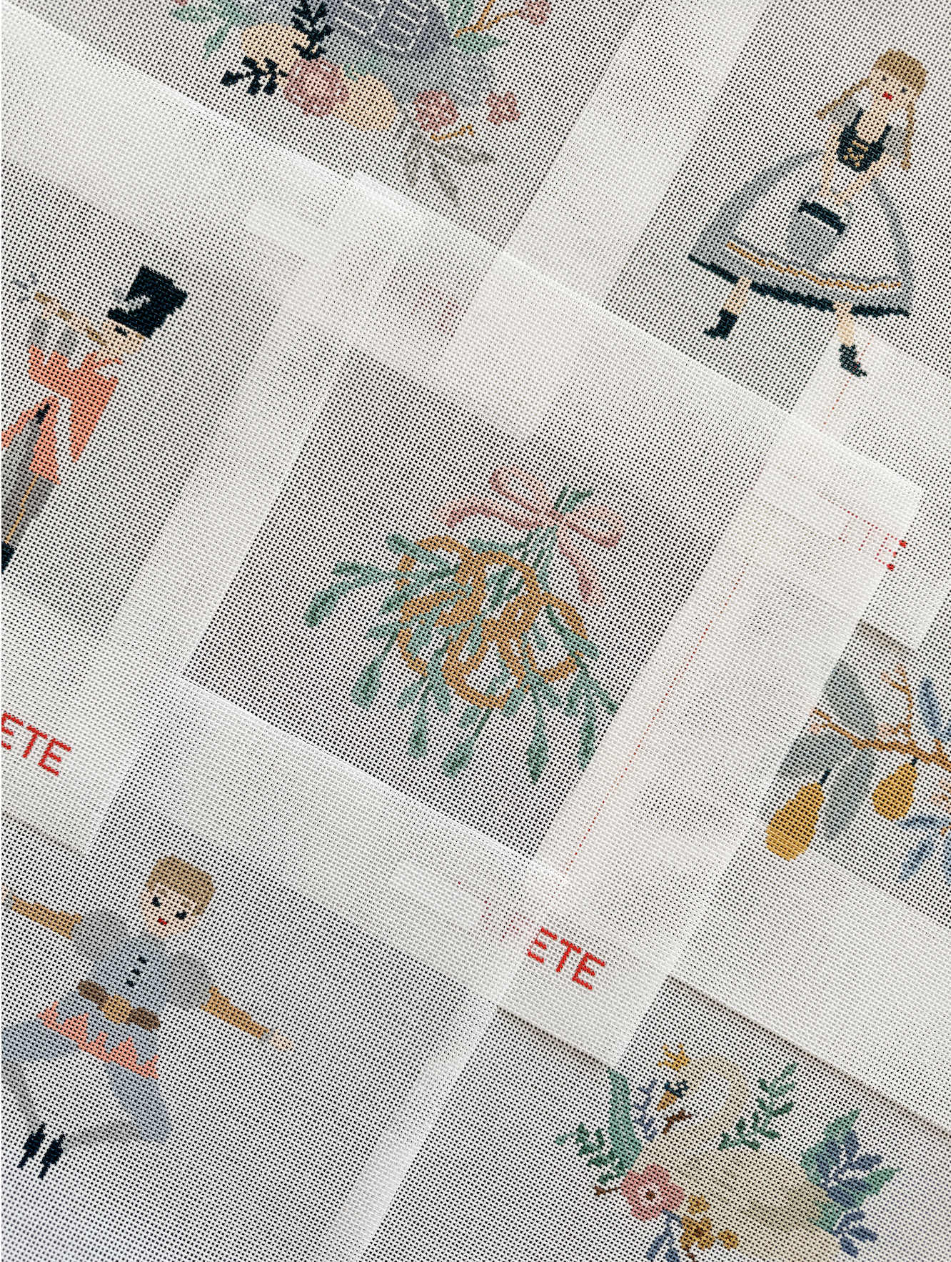 Cross-stitch pattern sheets featuring various colorful holiday-themed designs, including a reindeer, a Christmas tree, a Santa Claus, a candle, and other festive motifs.