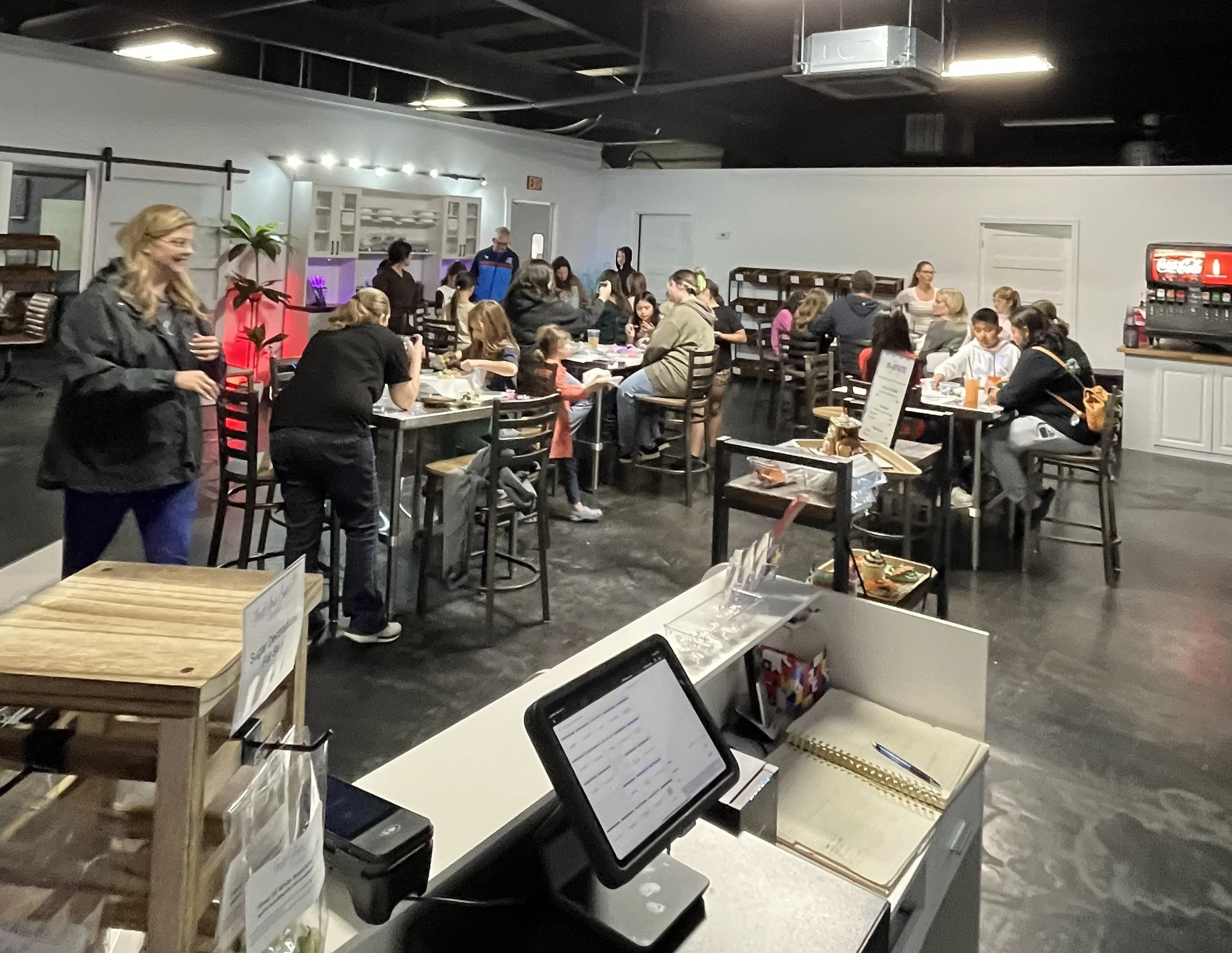 Inside view of Frost Your Cake Studio full of decorators enjoying open decorating as the celebrate the end of their soccer team's season