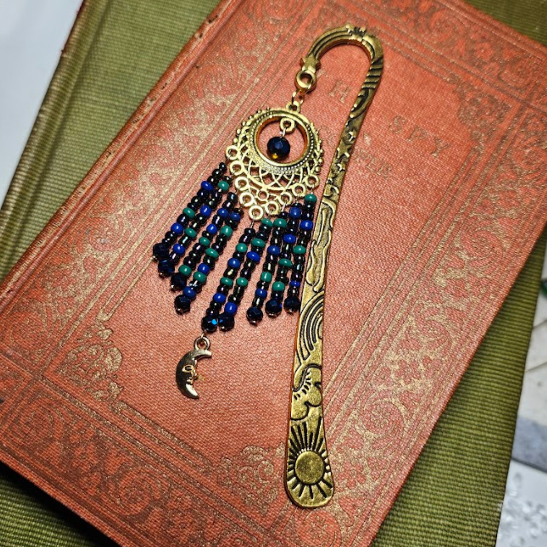 A decorative book with a tassel bookmark placed on a textured fabric surface.