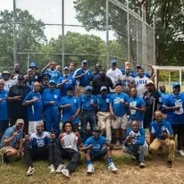 Fraternity brothers posing for a photo at a cookout.