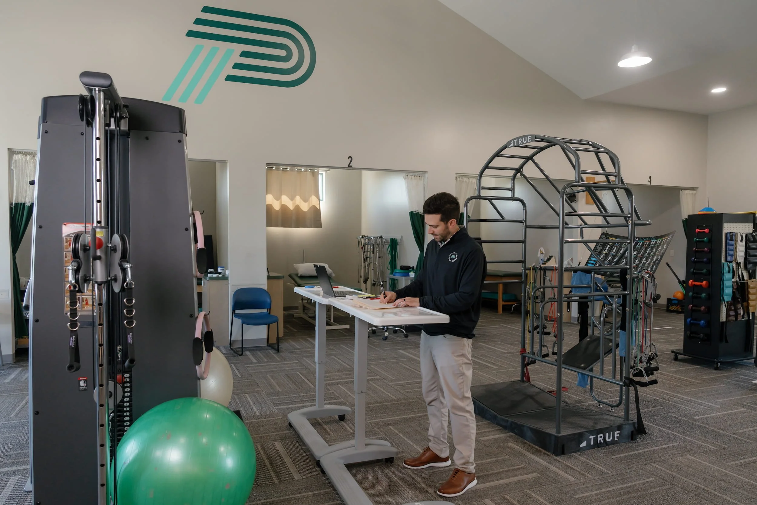 Physical therapist planning for the day in gym
