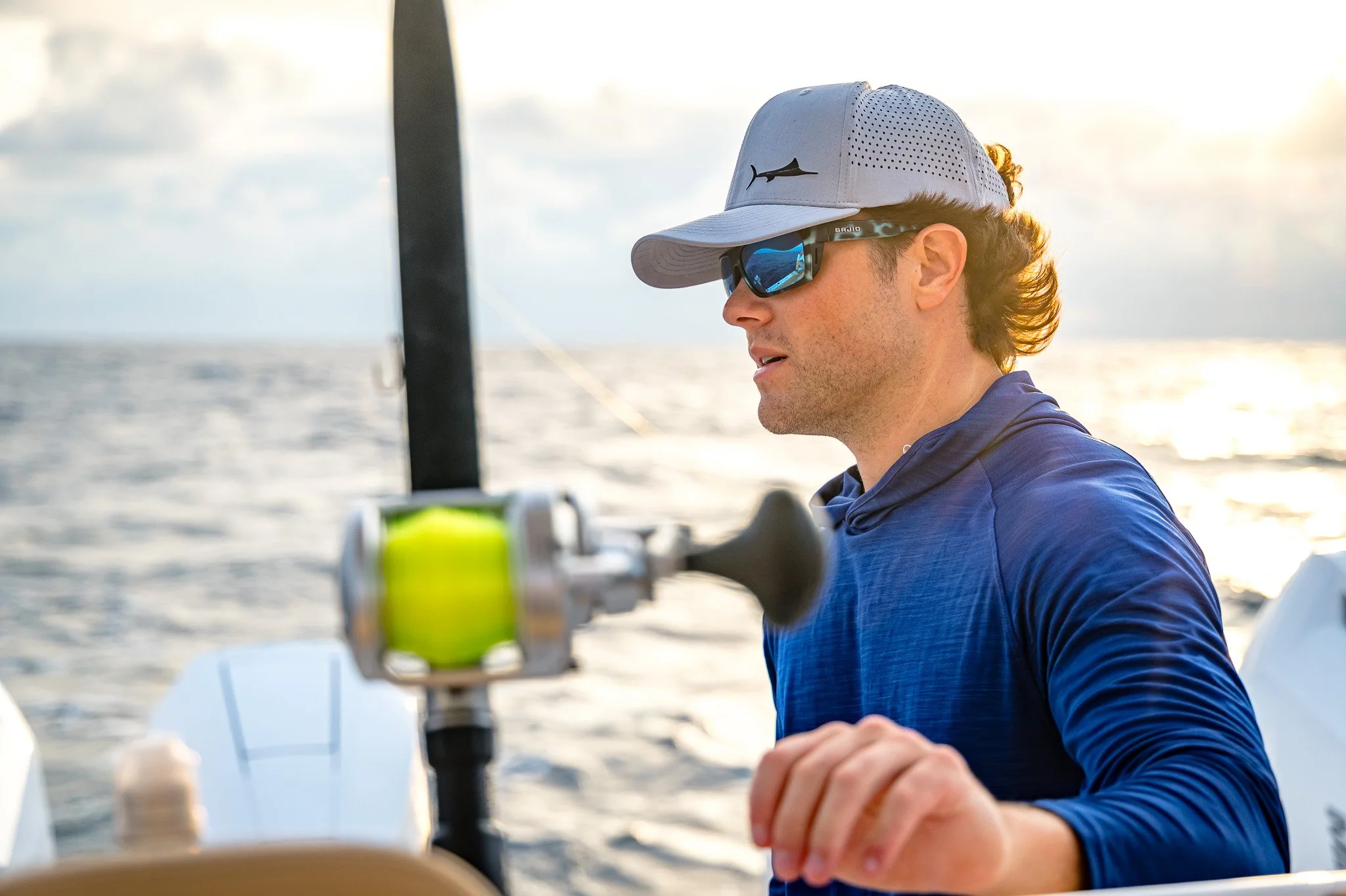 Person wearing high-performance offshore apparel on the water, showcasing technical fishing gear designed for demanding offshore conditions.