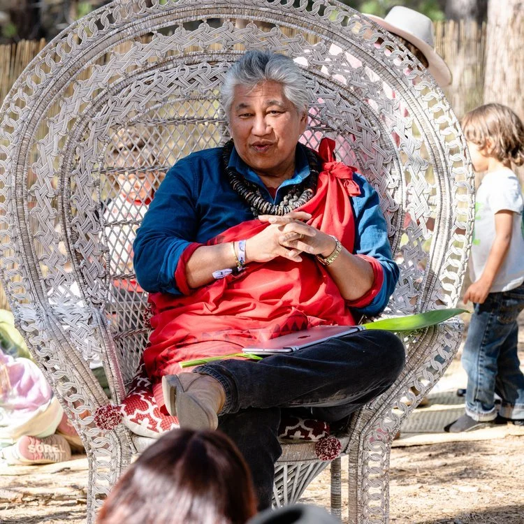 Person sitting in a large wicker chair outdoors