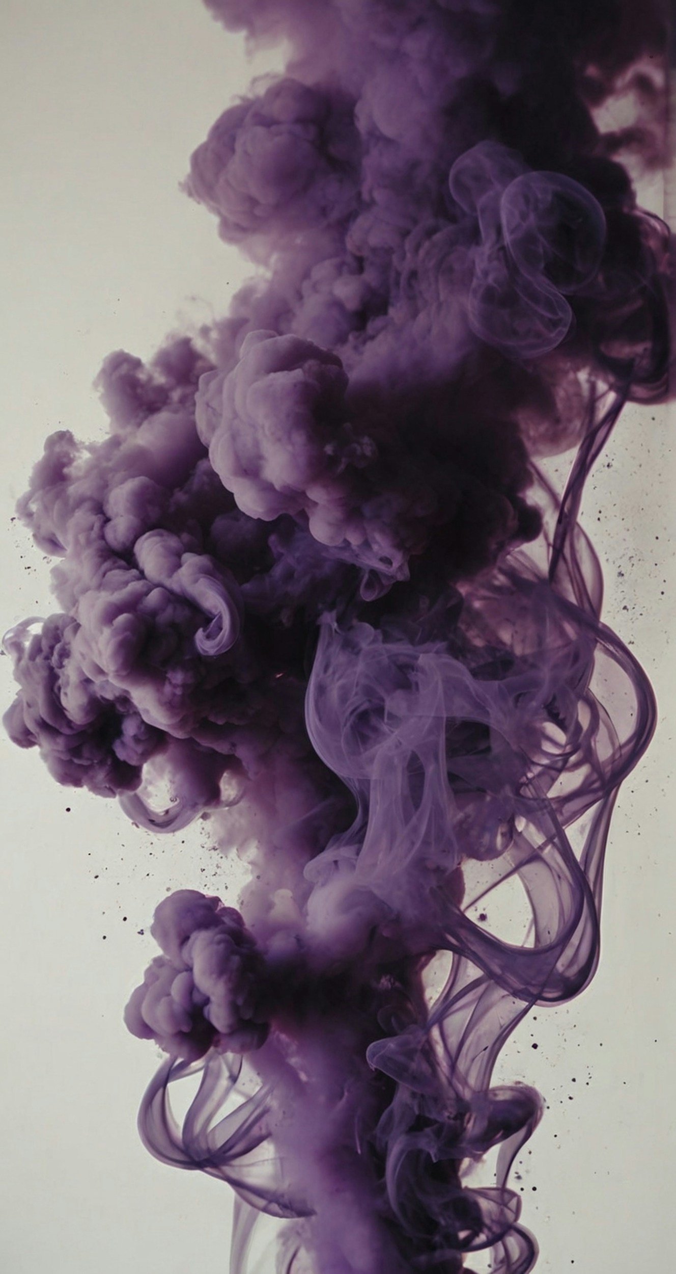 Purple smoke or ink swirling and billowing upwards in a vertical formation against a light background.