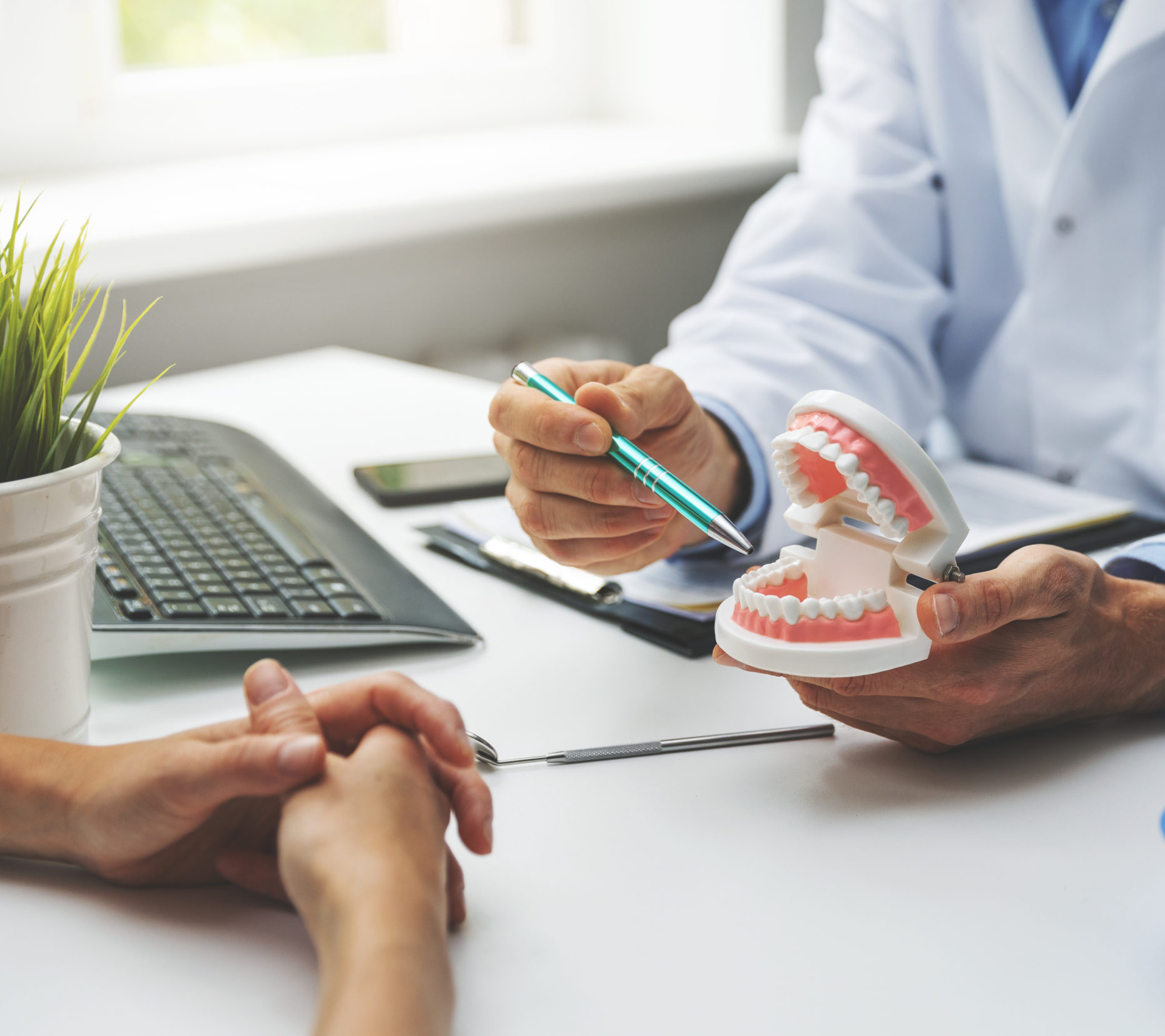Dentist pointing at tooth