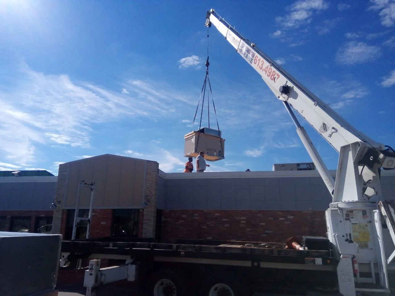 HVAC unit crane lift installation at commercial building in the Oklahoma City area