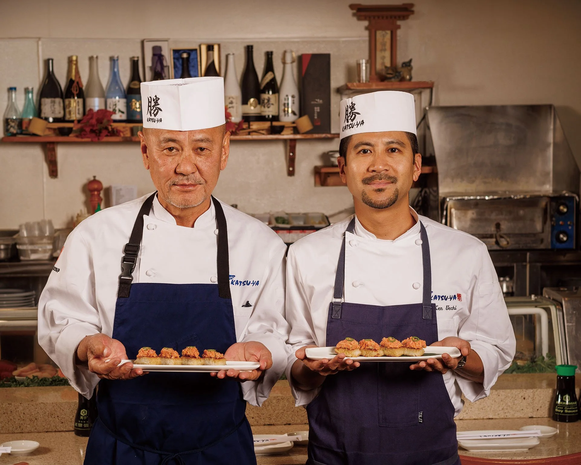 Chef Katsuya and his son Ken both holding Spicy Tuna on Crispy Rice. KATSU-YA'  Photograph by Gary Rose at the Original Katsuya restaurant   Group (@katsuyagroup) Katsu-ya Group #SushiLovers #StudioCity #SushiRow