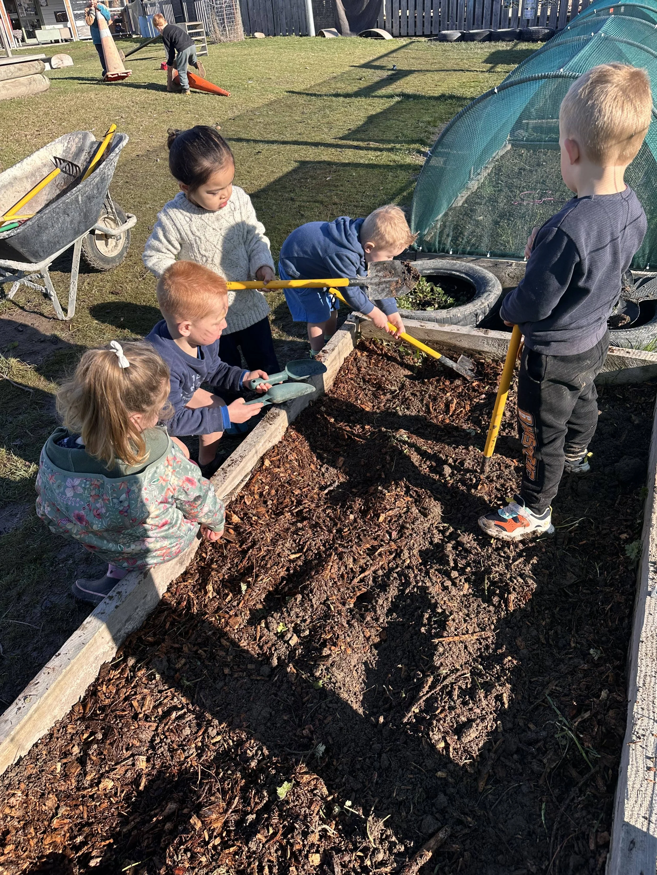 Children working in a garden bed at Country Wonders Preschool