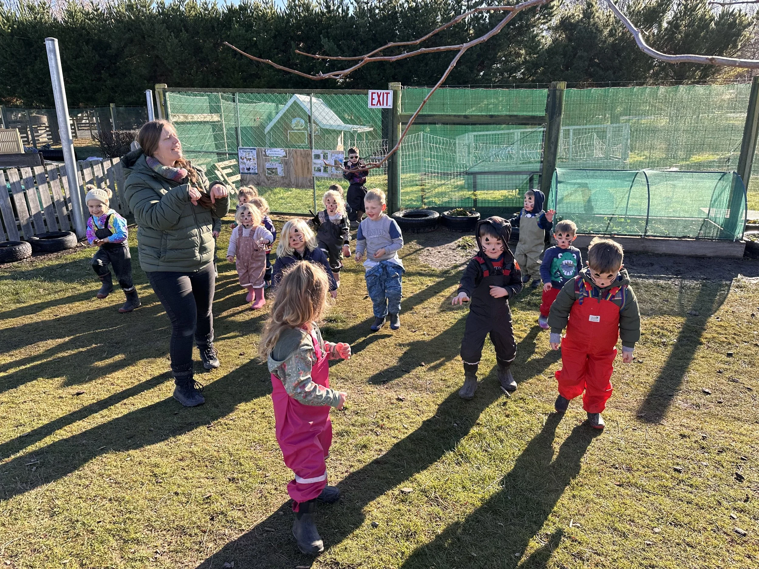 A group of young children with face paint and outdoors at Country Wonders childcare centre in Loburn, North Canterbury