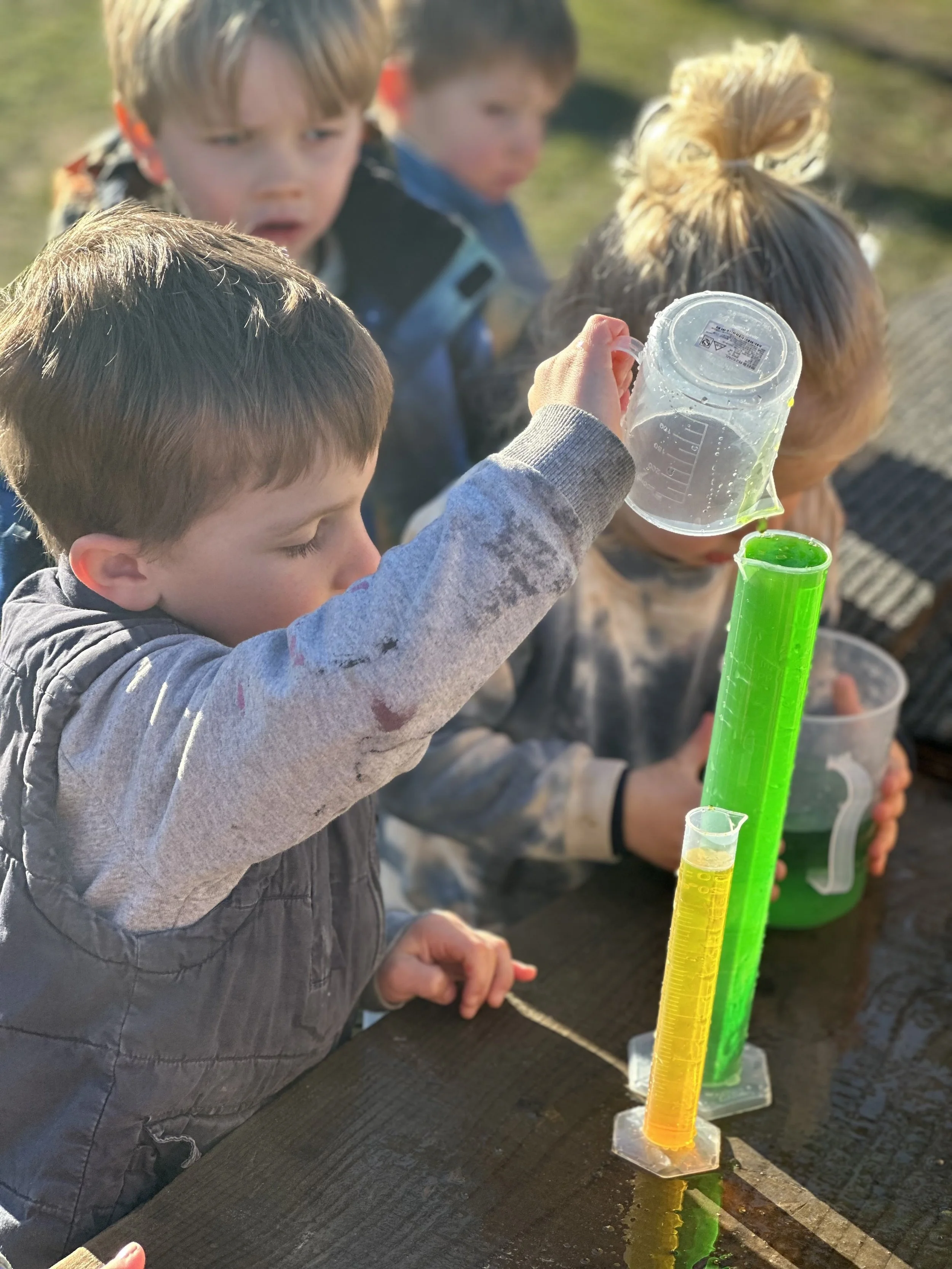 Preschool children doing a hands-on learning experiment at Country Wonders in North Canterbury