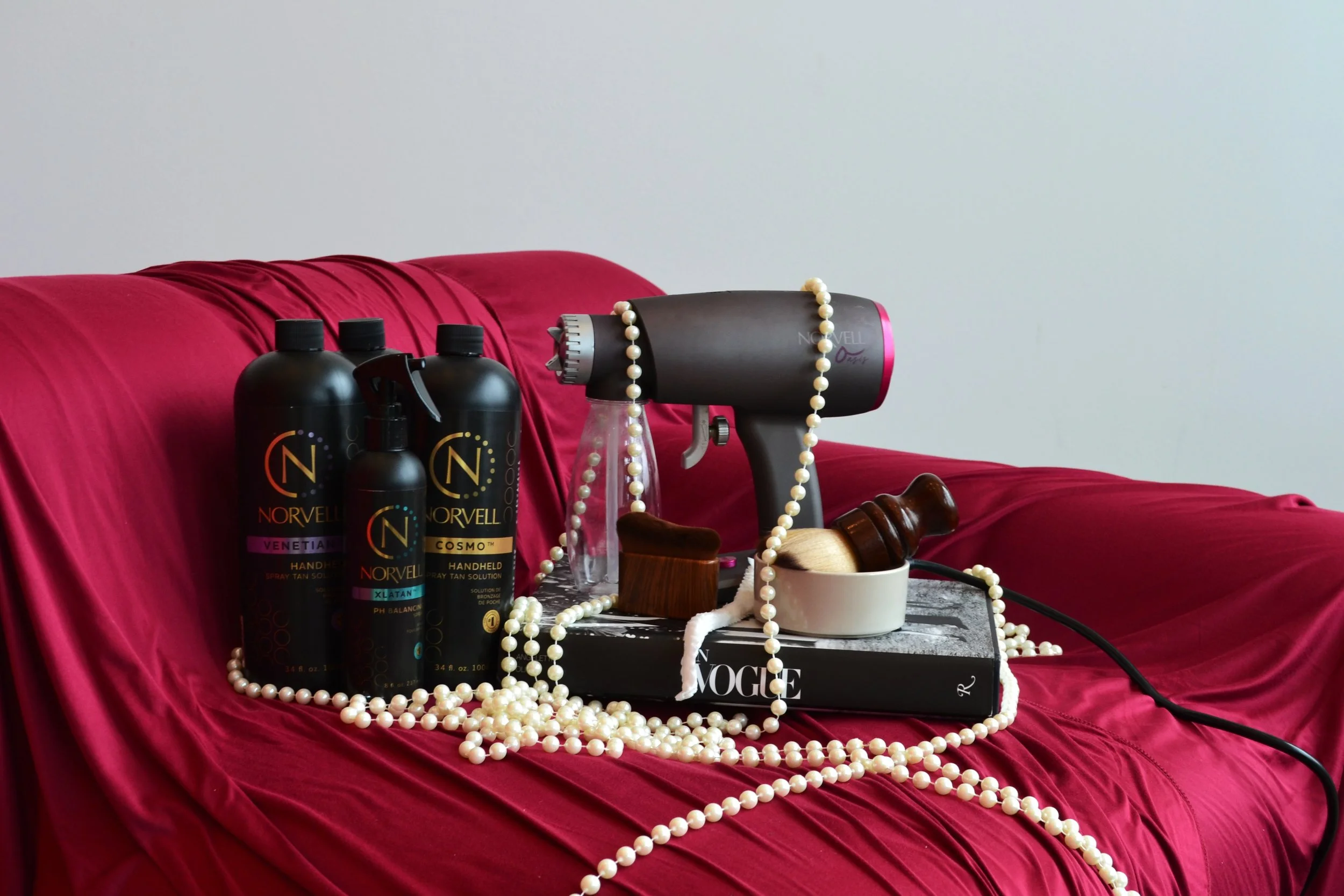 Tanning products surrounded by pearls