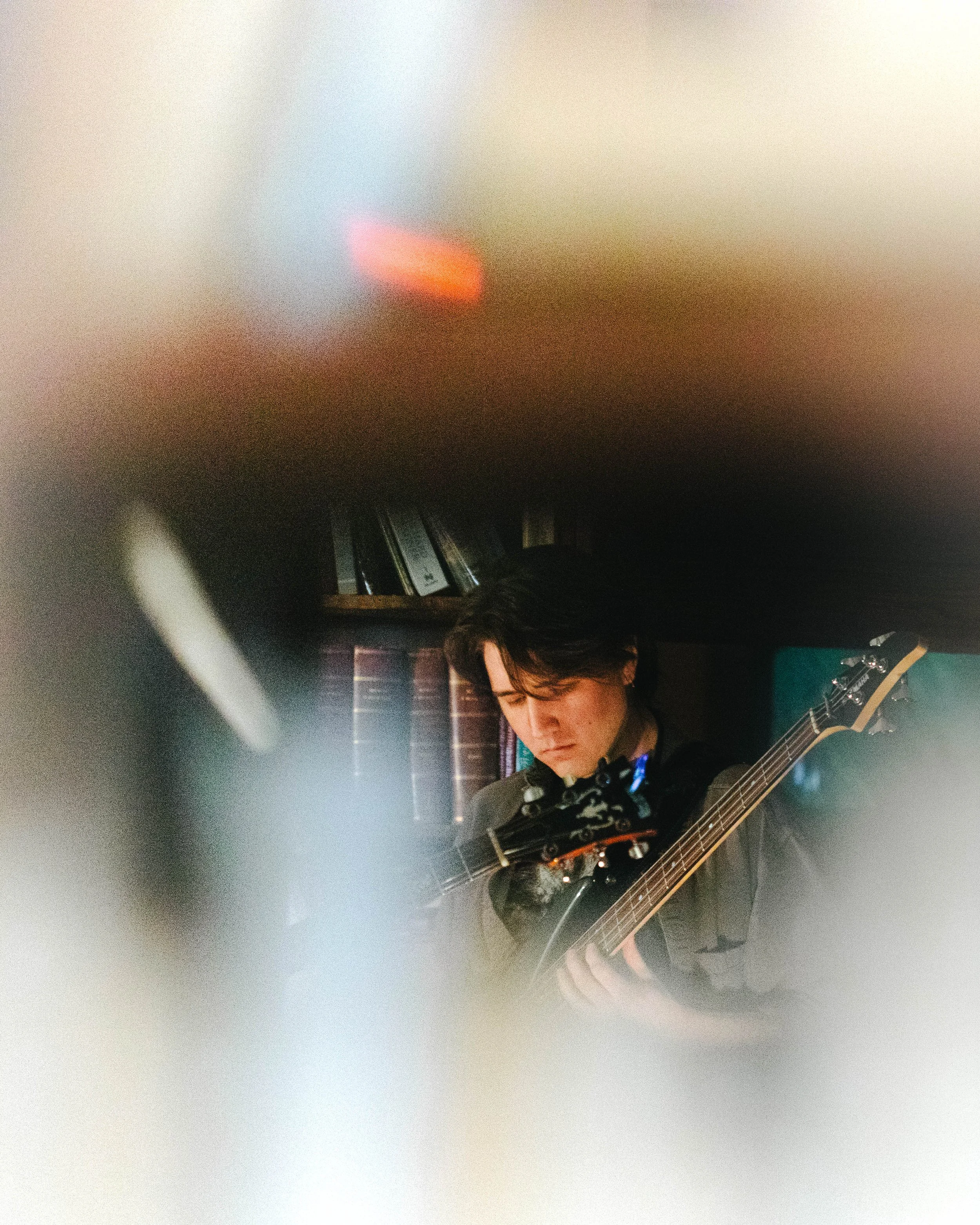 a blurry image with Jaxx standing with their bass poking through.