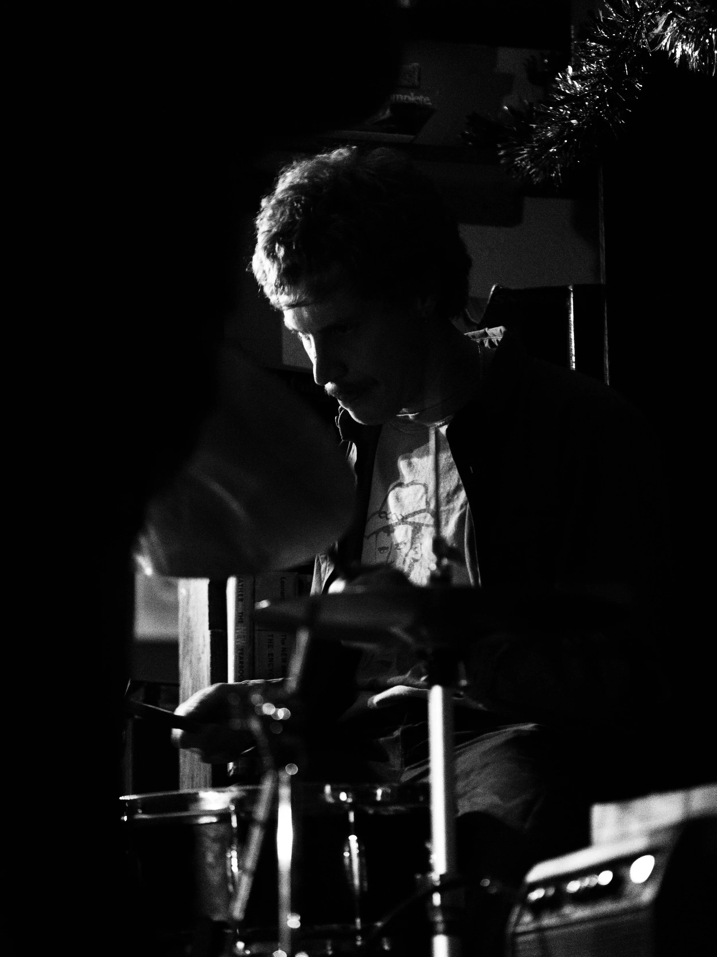a black and white photo of Steven on Drums.