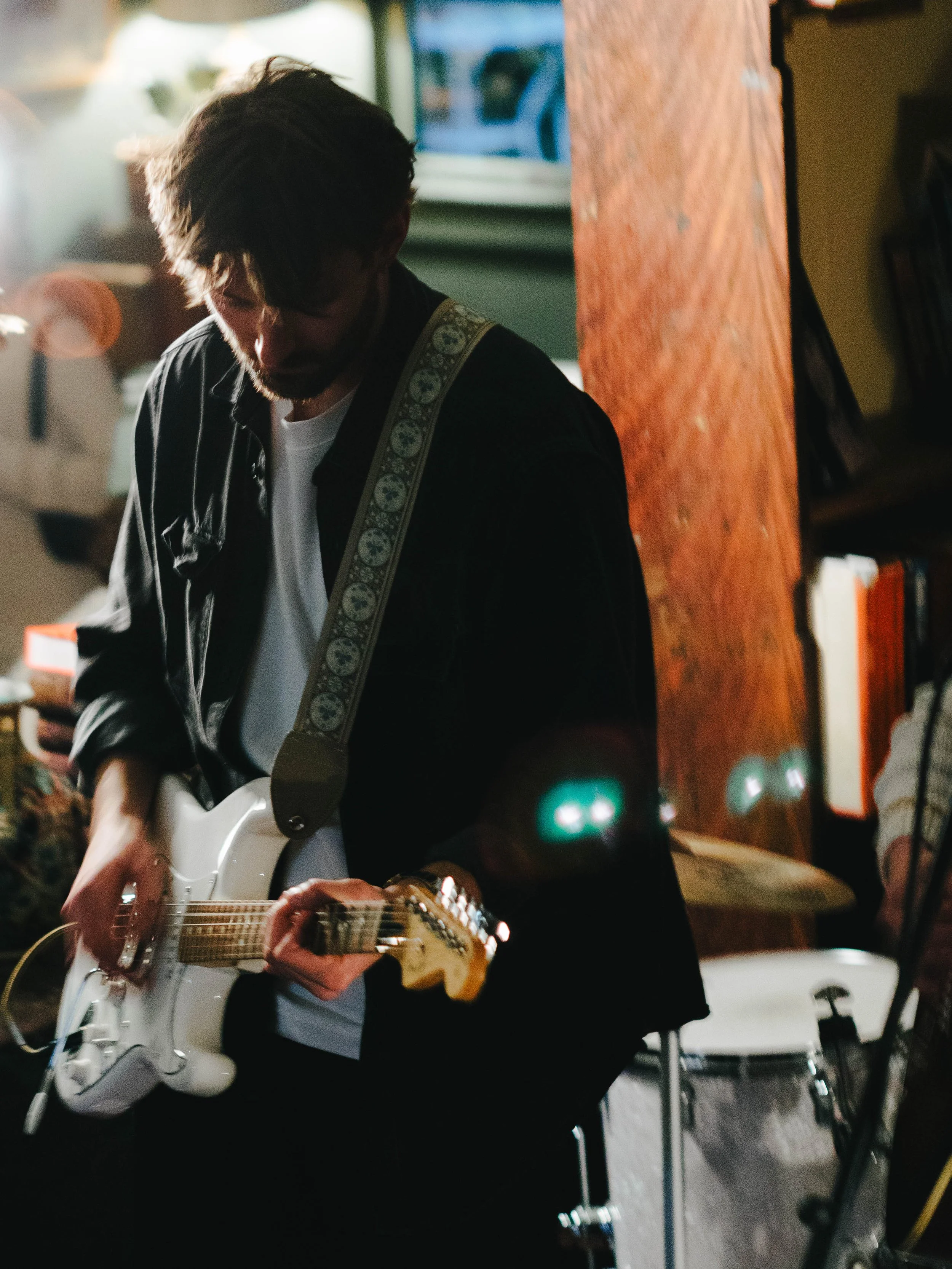 Paul standing with guitar. 