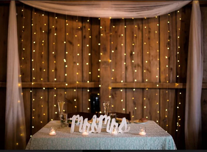 Curtain of Lights Behind Sweetheart Table
