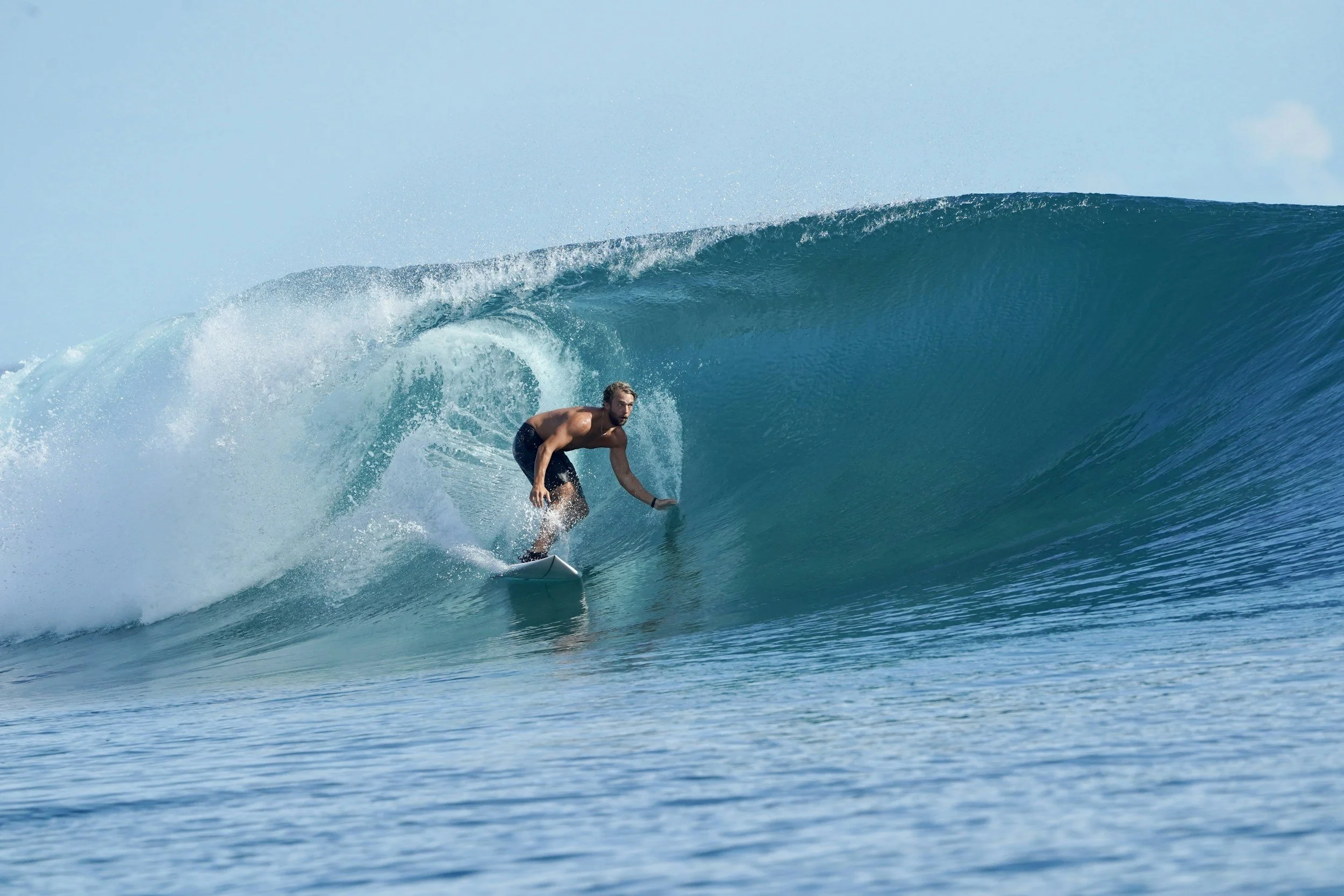 Man surfing on a large ocean wave
