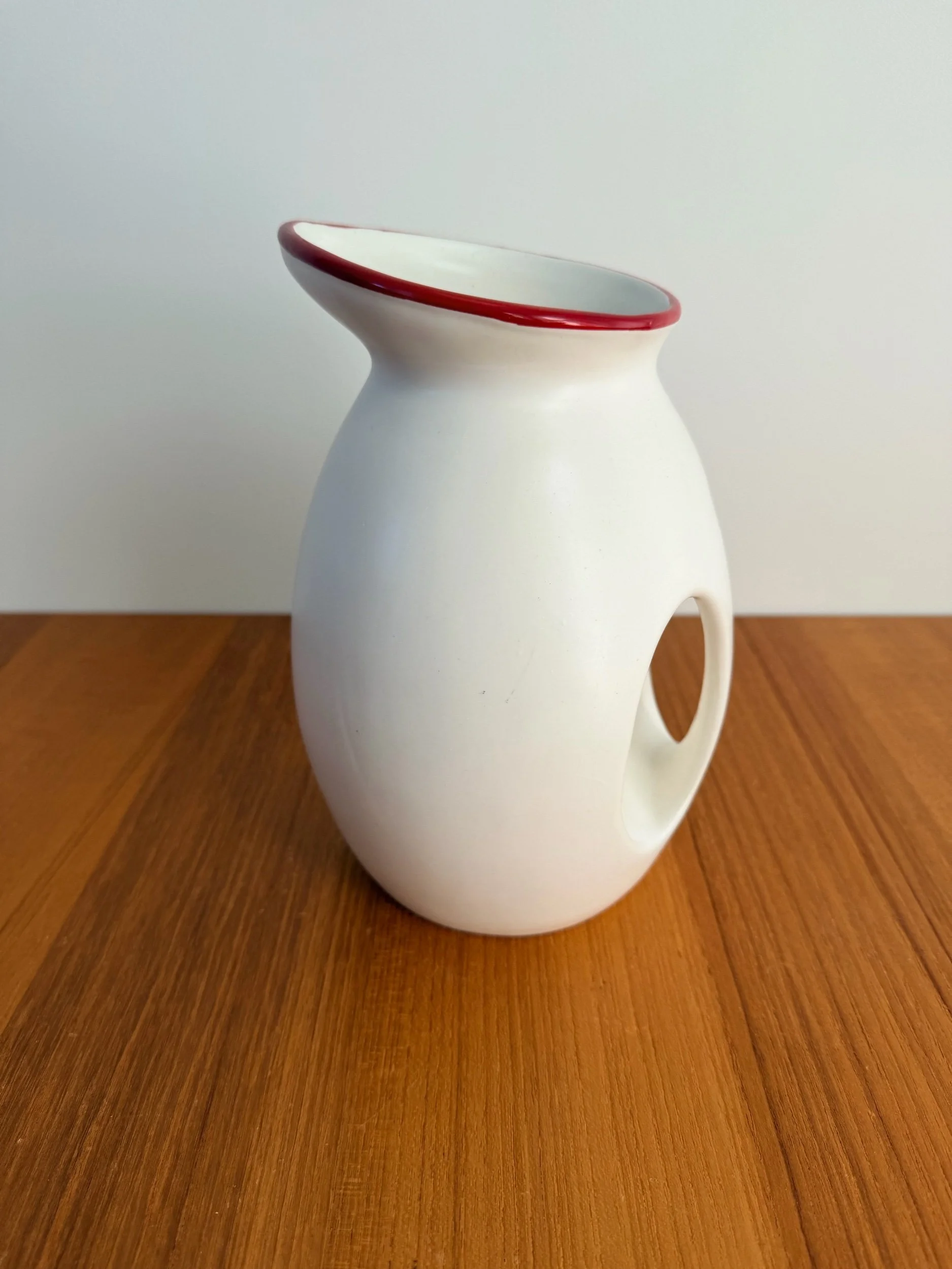 white & red ceramic pitcher
