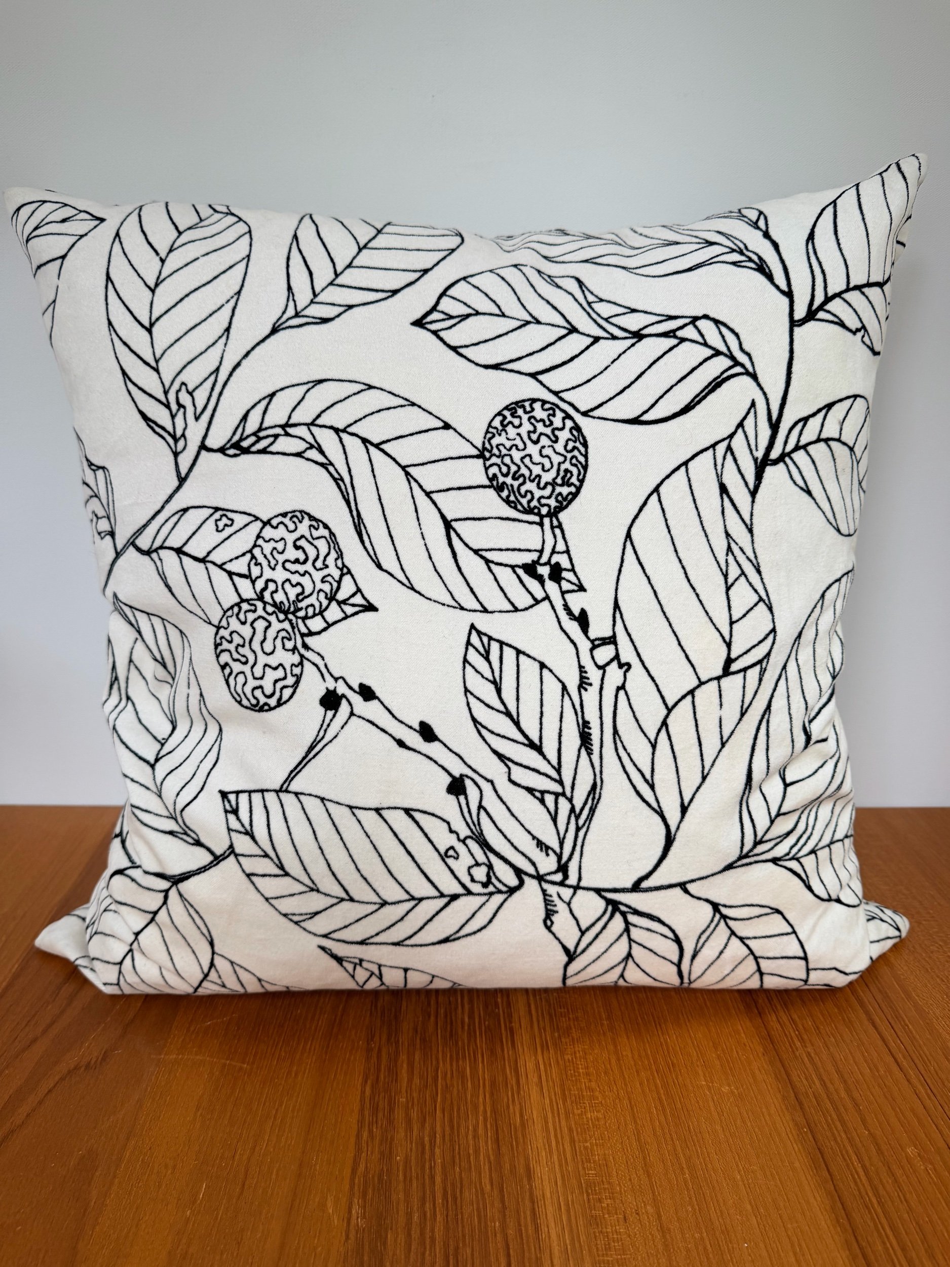 cream soft pillow with black leaf etching