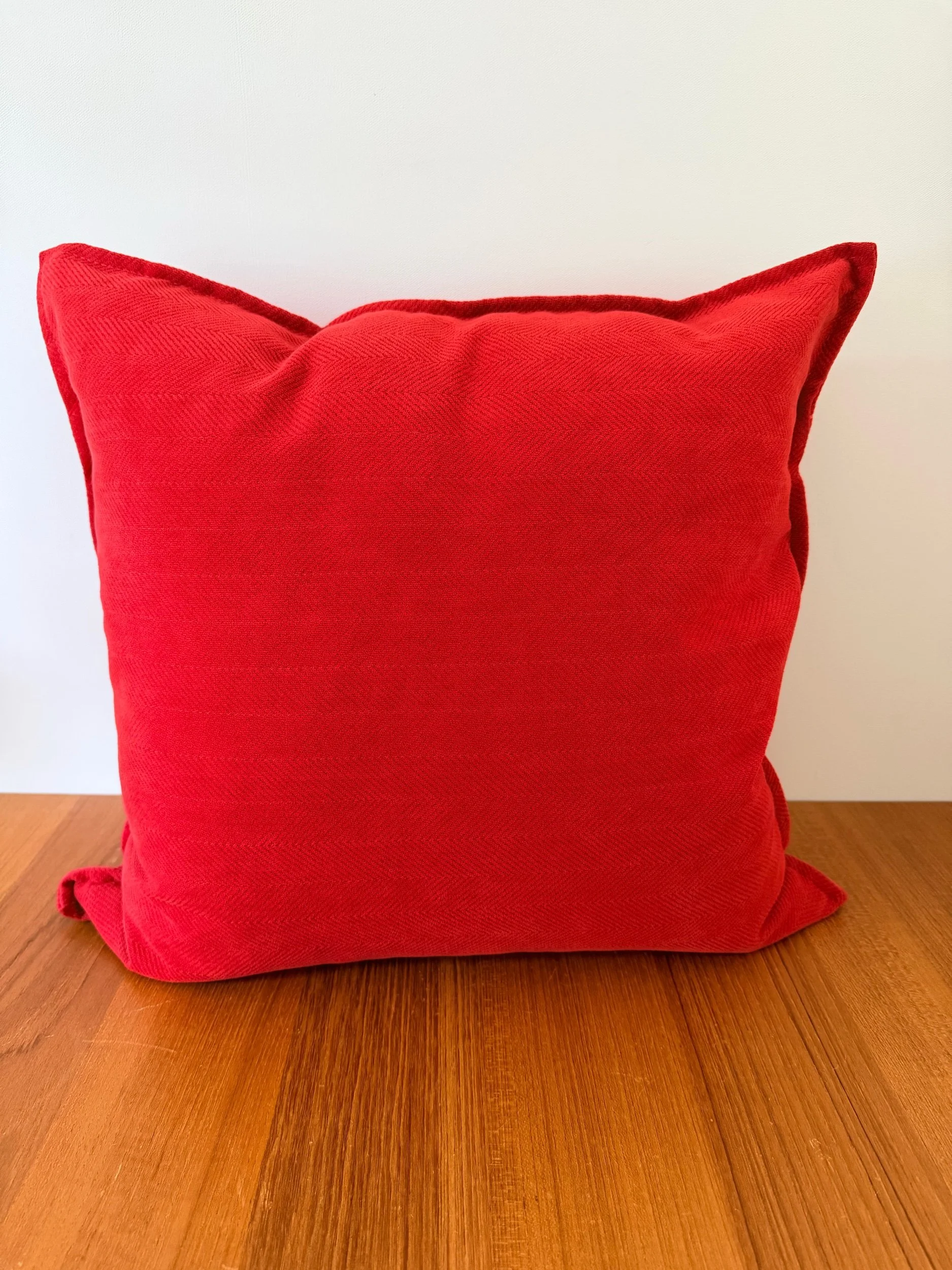 red pillow with subtle pattern