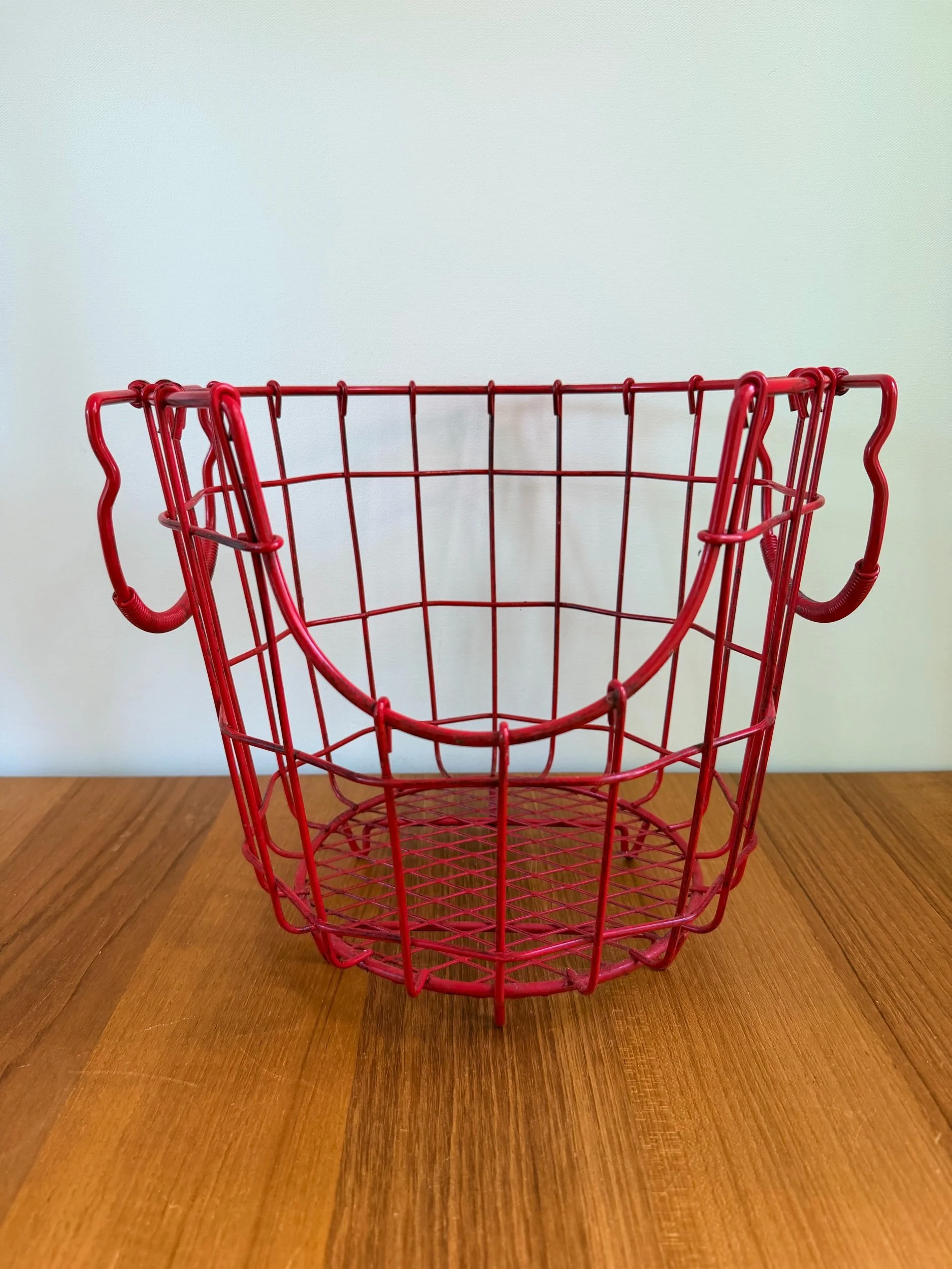 red metal basket with handles