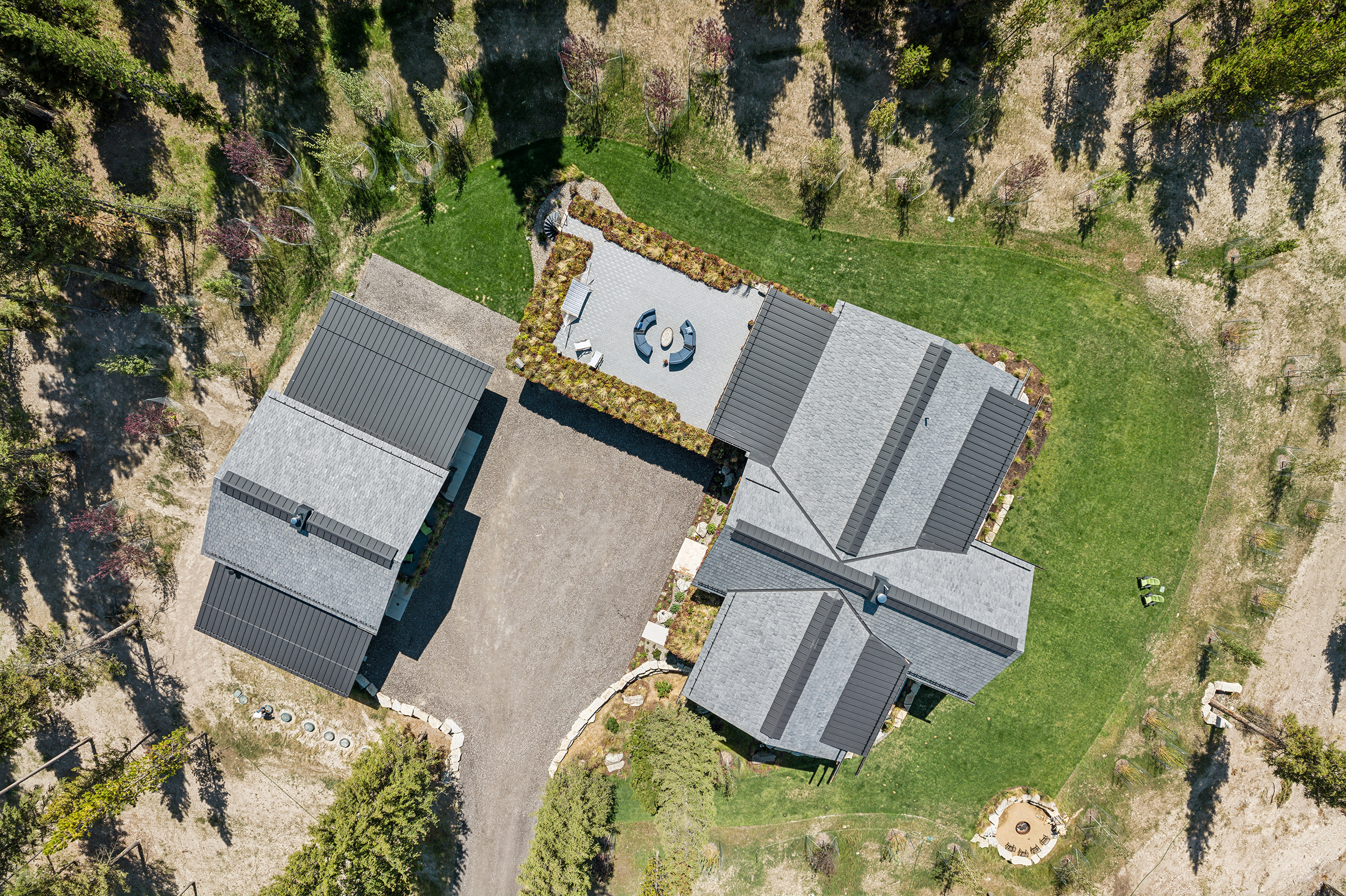 Aerial view of large residential estate with Brava synthetic slate roofing in charcoal gray across multiple structures, premium roofing Sun Valley Idaho