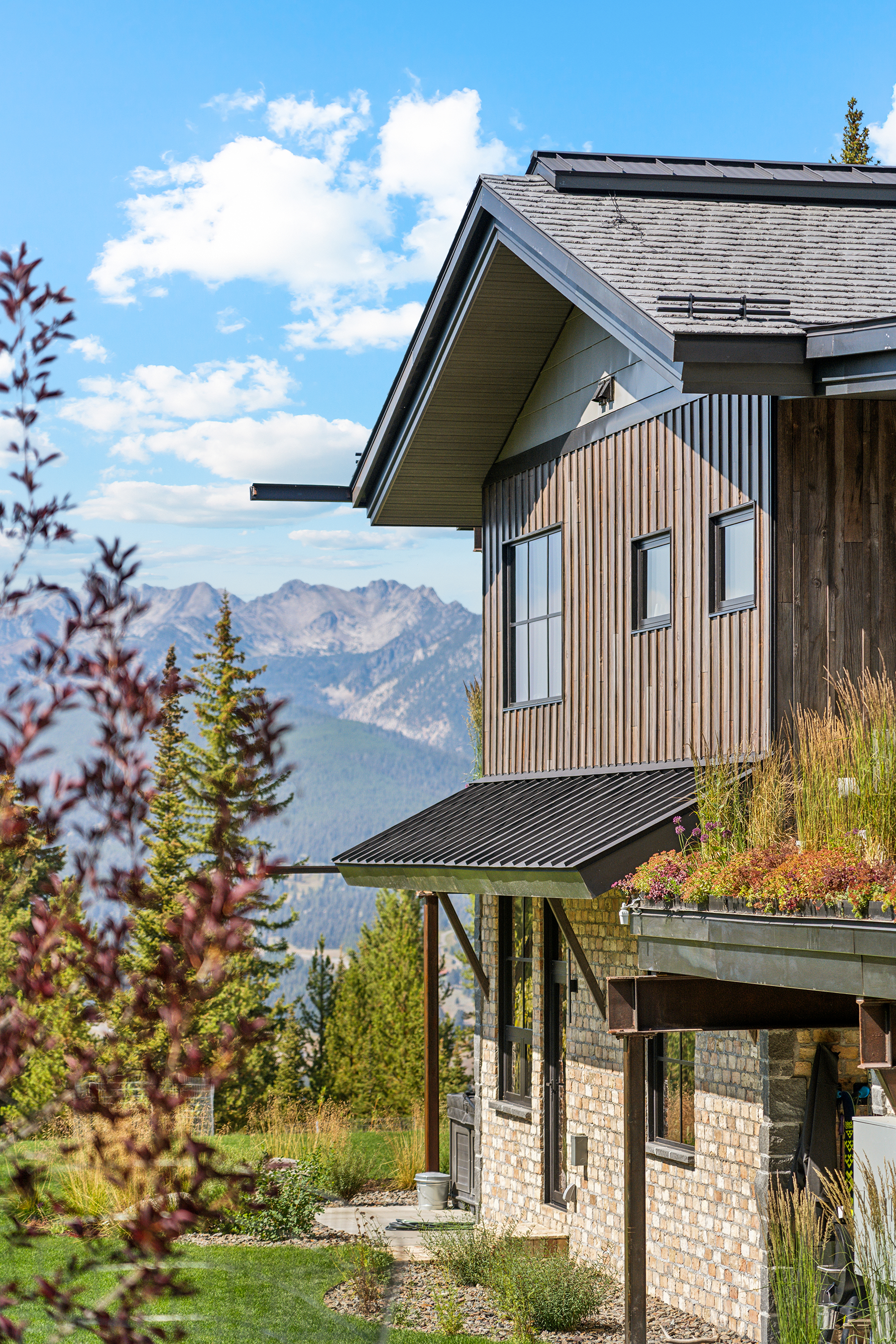 Brava synthetic slate roofing on a contemporary mountain home with vertical siding and panoramic Rocky Mountain views, luxury roofing Sun Valley Idaho