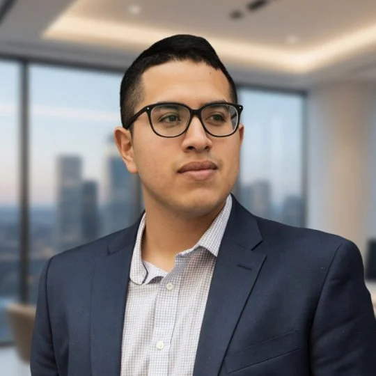 Professional man in a suit and glasses in a high-rise office with city view