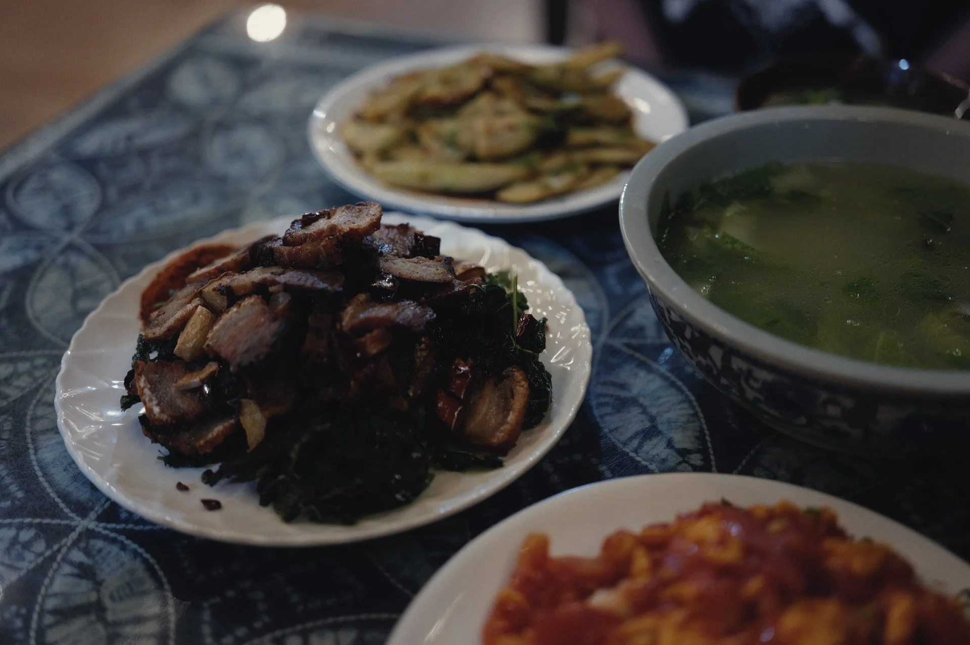 Home-cooked pork, vegetables, soup and rice served at Qi Feng Shan Homestay in Tiger Leaping Gorge.