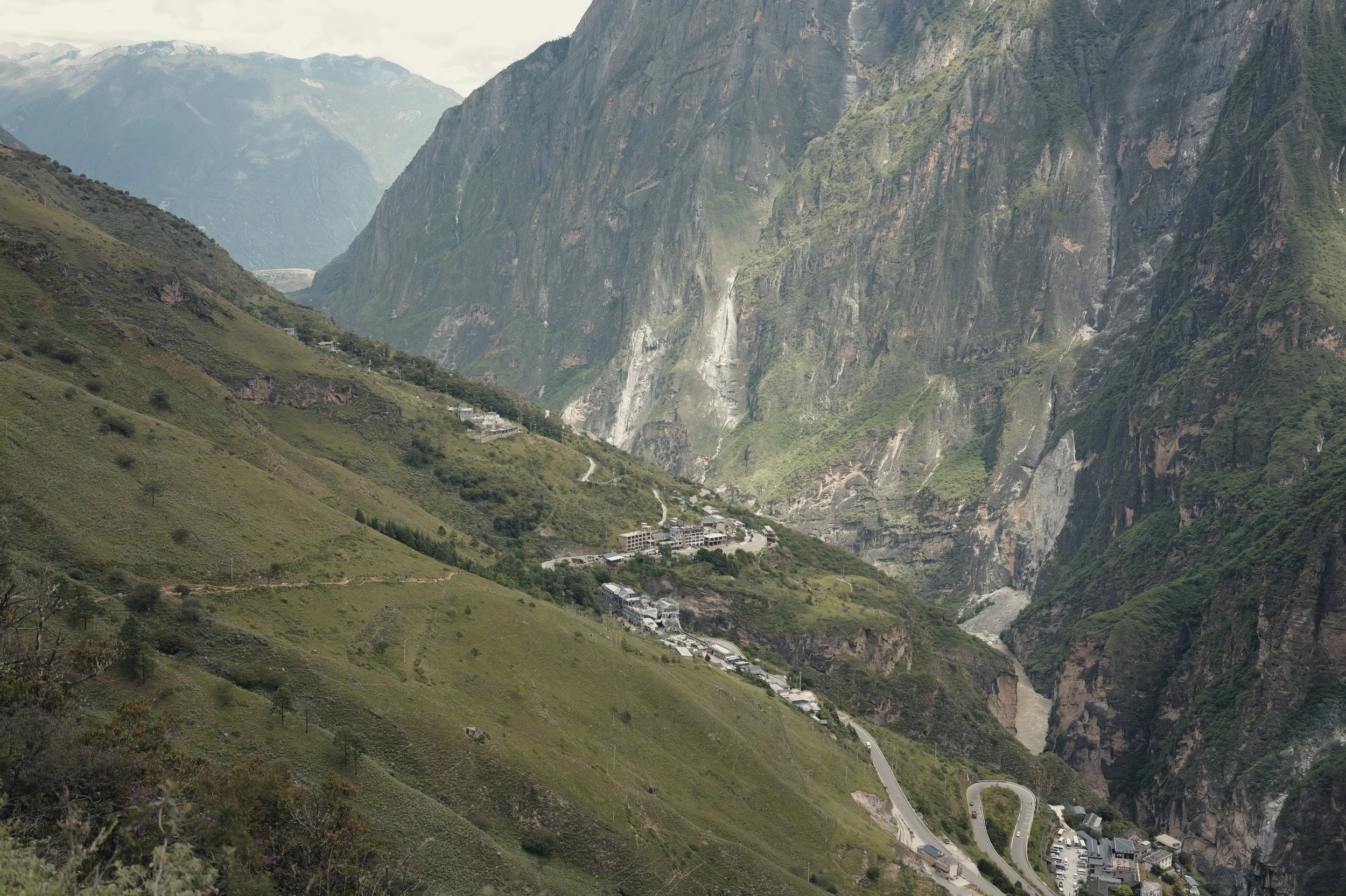 Village road winding through the cliffs of Tiger Leaping Gorge, Yunnan, photographed with a Leica Q3 43