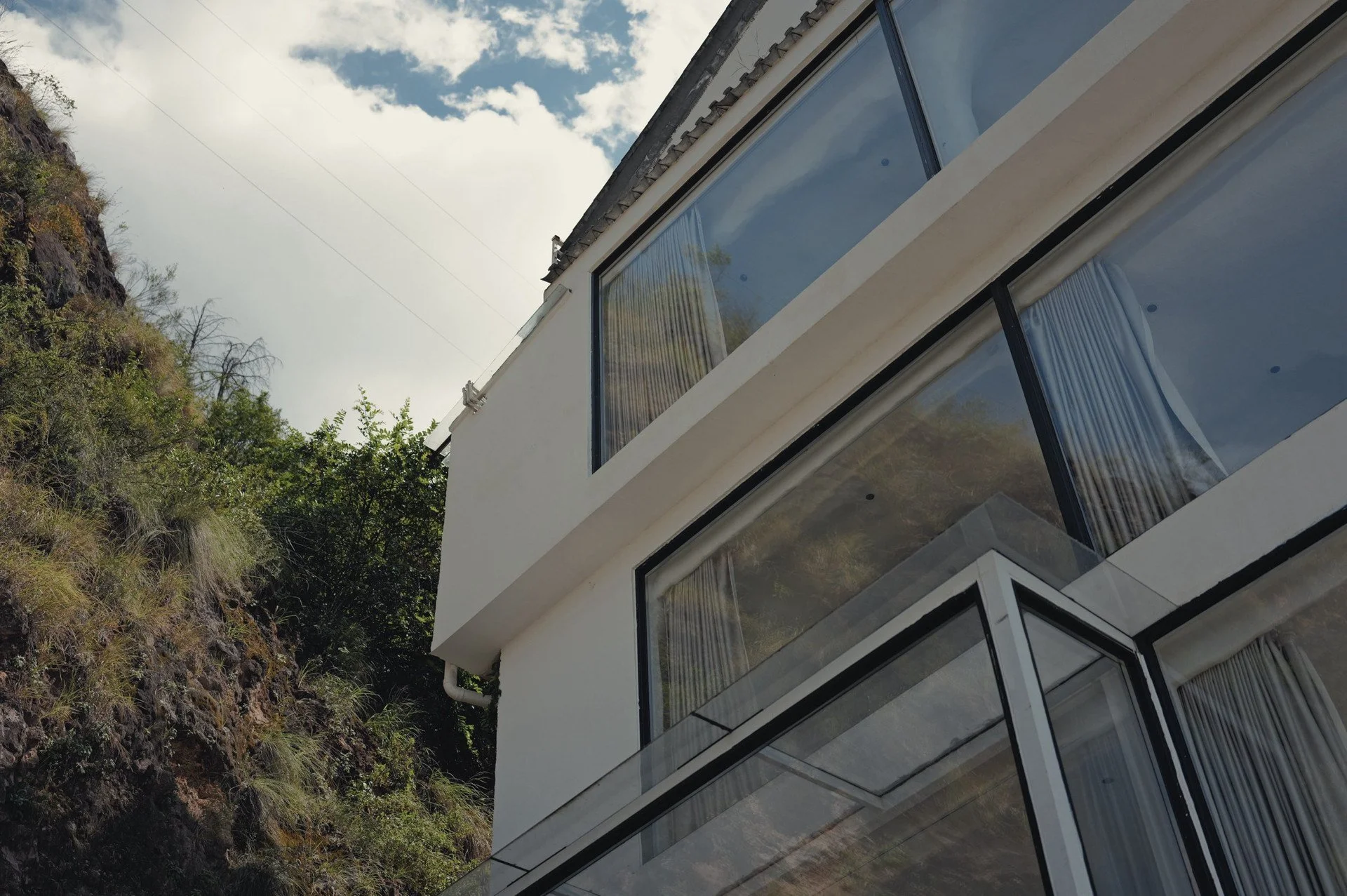 White facade and angular windows at Qinglan Cave Style Hotel beside Erhai Lake in Dali, Yunnan.