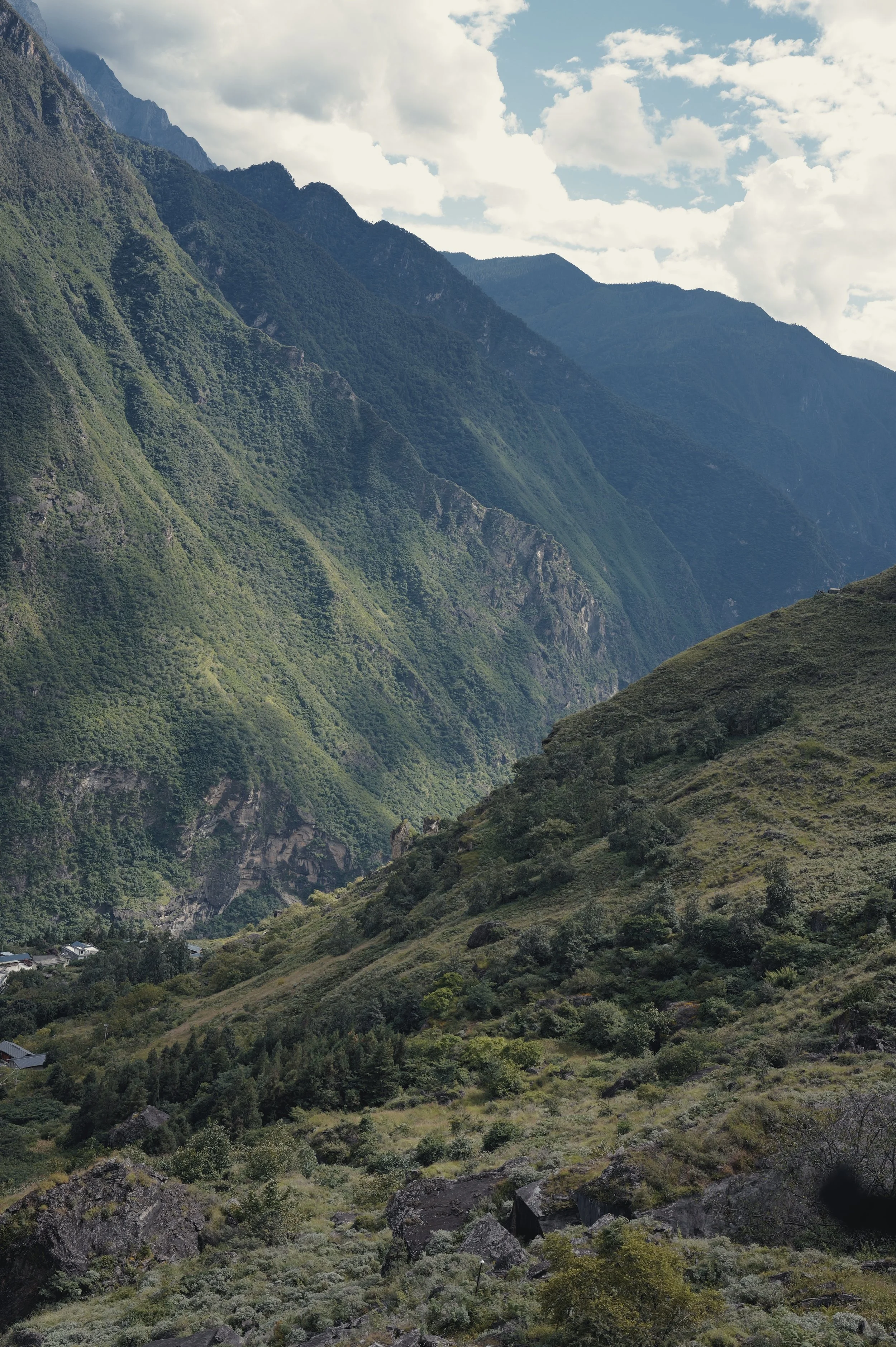 Steep green valley walls in Tiger Leaping Gorge, Yunnan