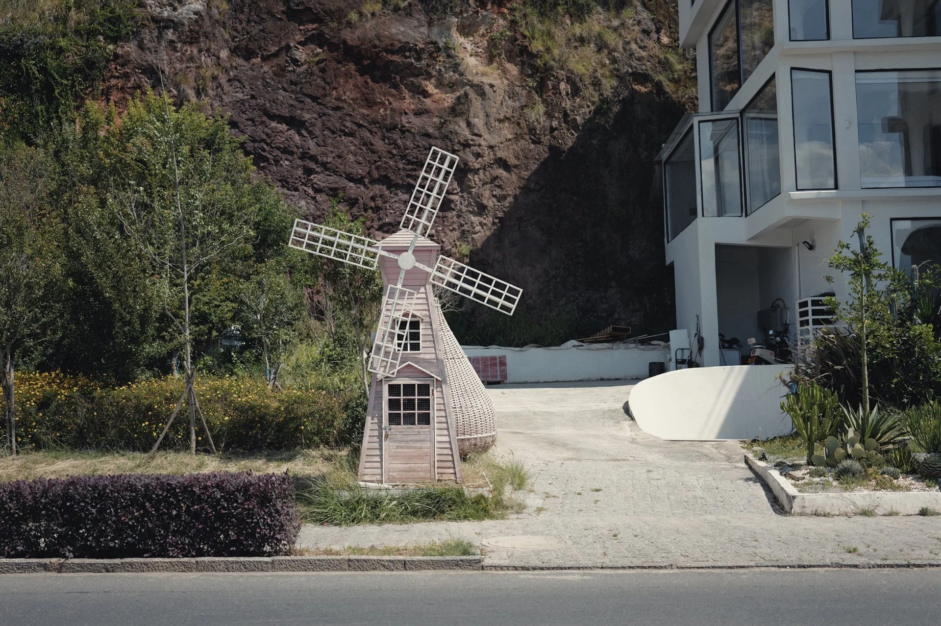 Small white decorative windmill outside Qinglan Cave Style Hotel beside Erhai Lake in Dali, Yunnan.
