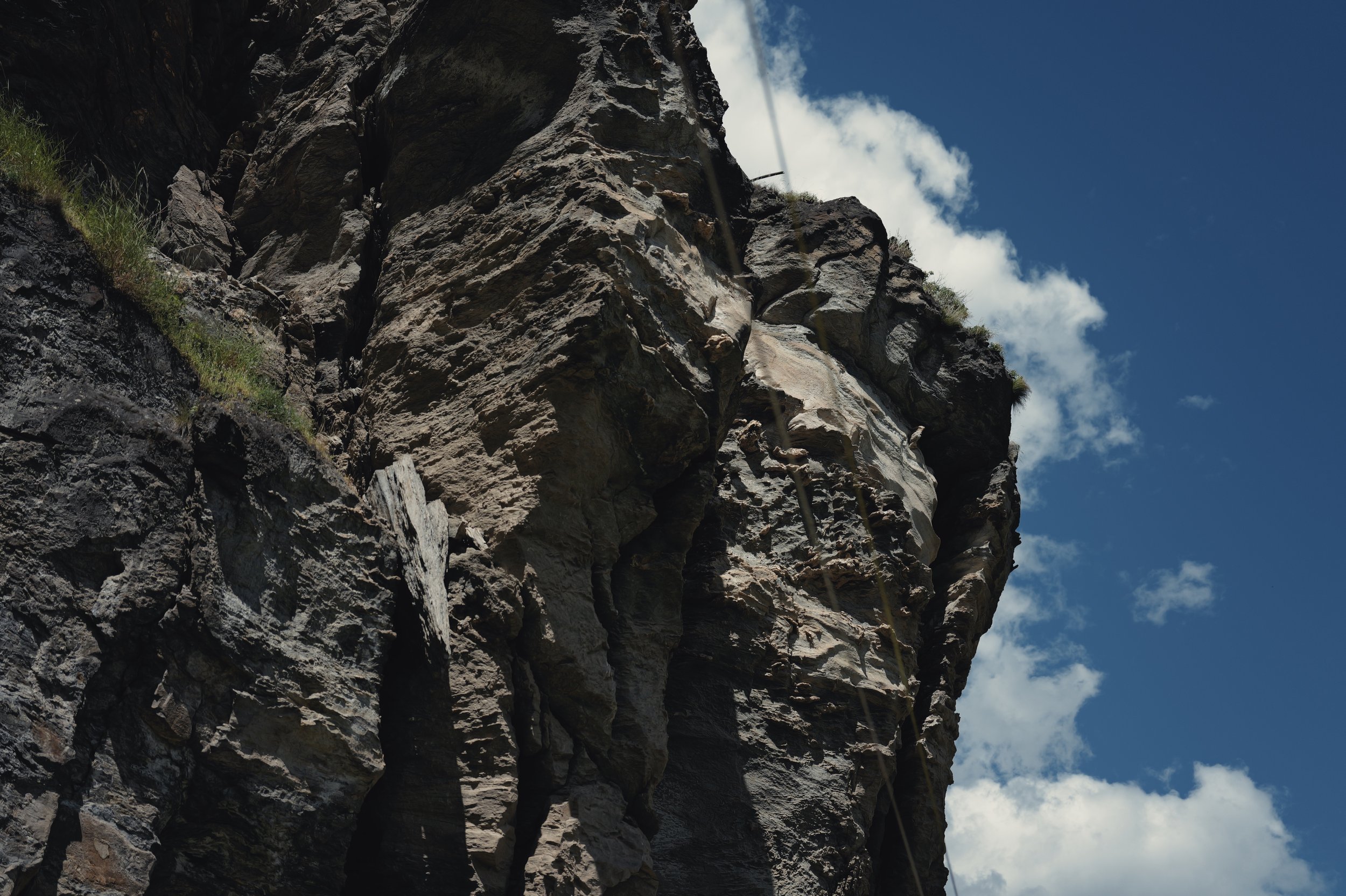 Jagged rock formation against blue sky in Tiger Leaping Gorge