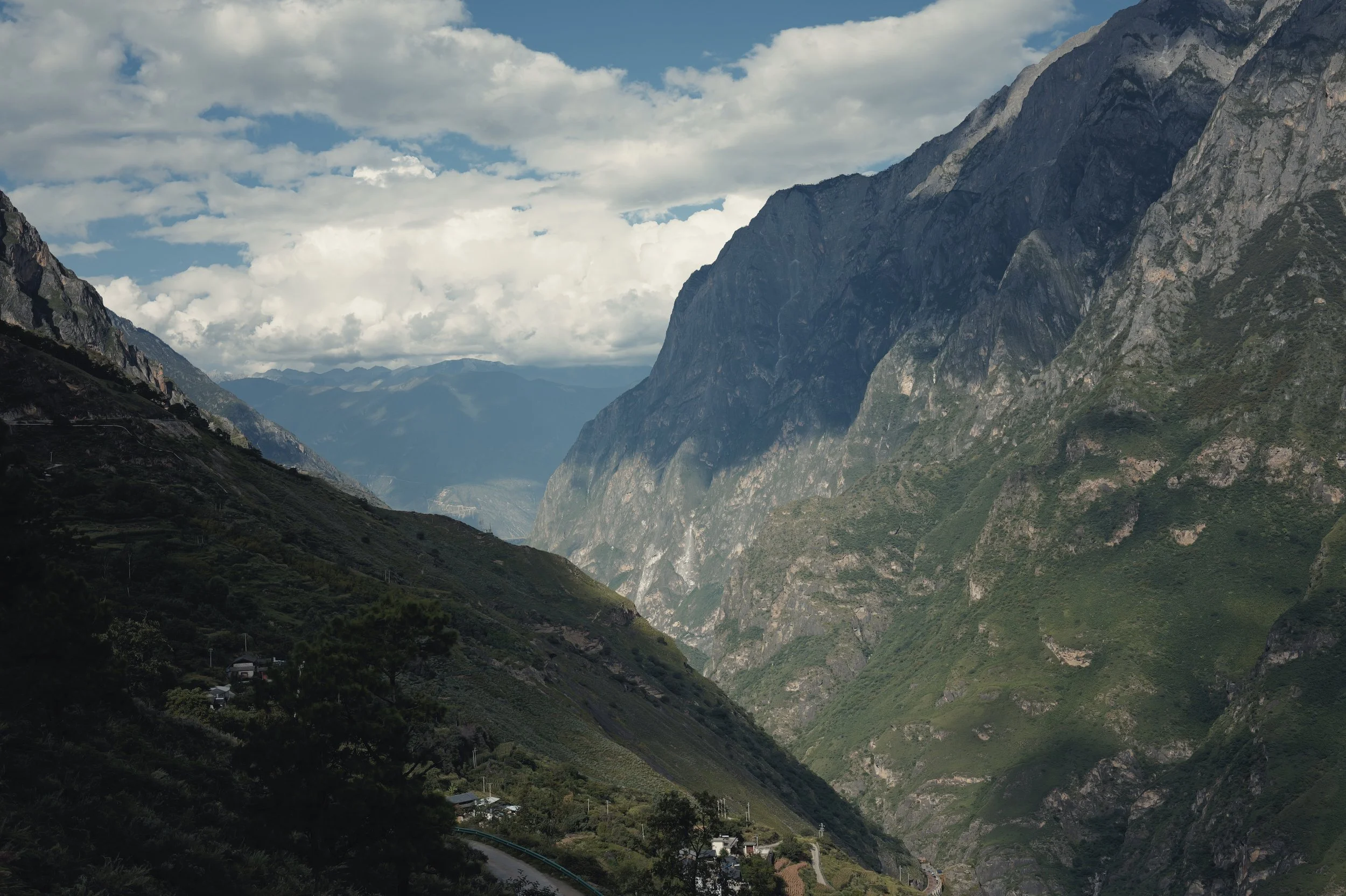 Sunlit mountain valley along the Tiger Leaping Gorge hiking trail