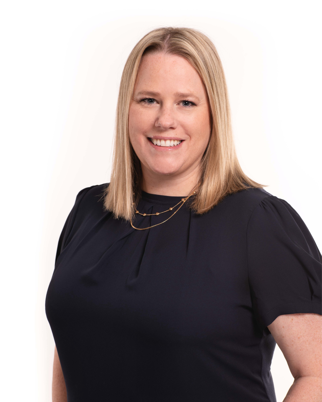 Mandy Morton, business intuitive, smiling in a dark blue top agains a white background.