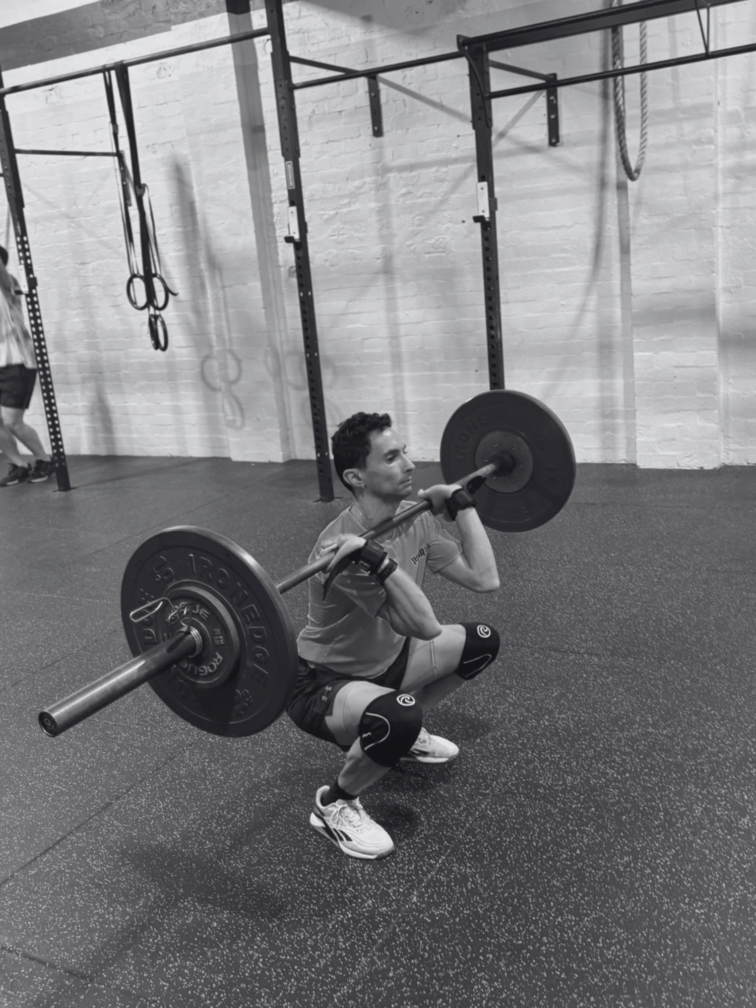 man completing an olympic lift of the clean and jerk