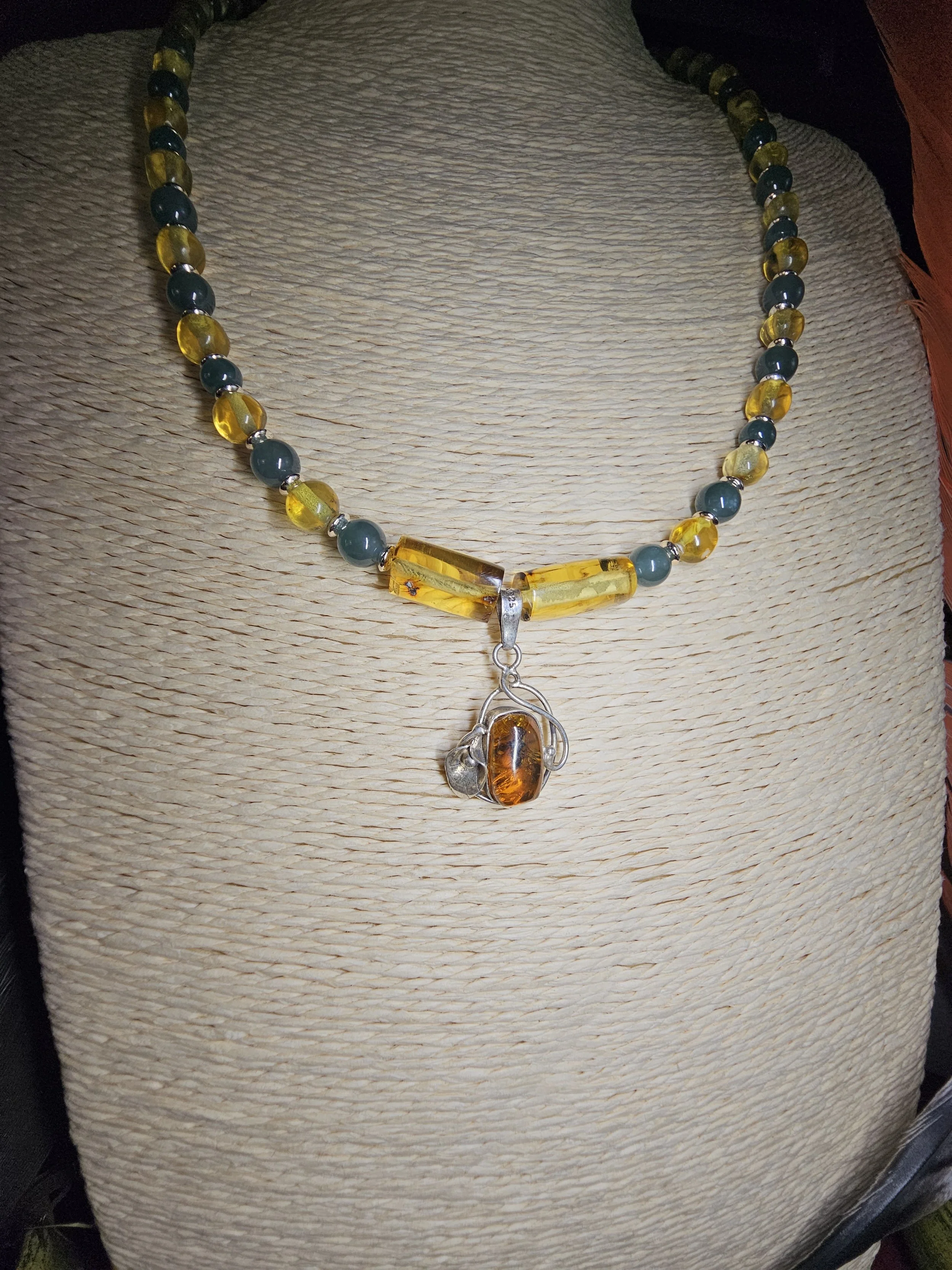 chiapas-amber-jade-bead-necklace-cognac-amber-silver-scroll-pendant-detail_xugbyb.jpg