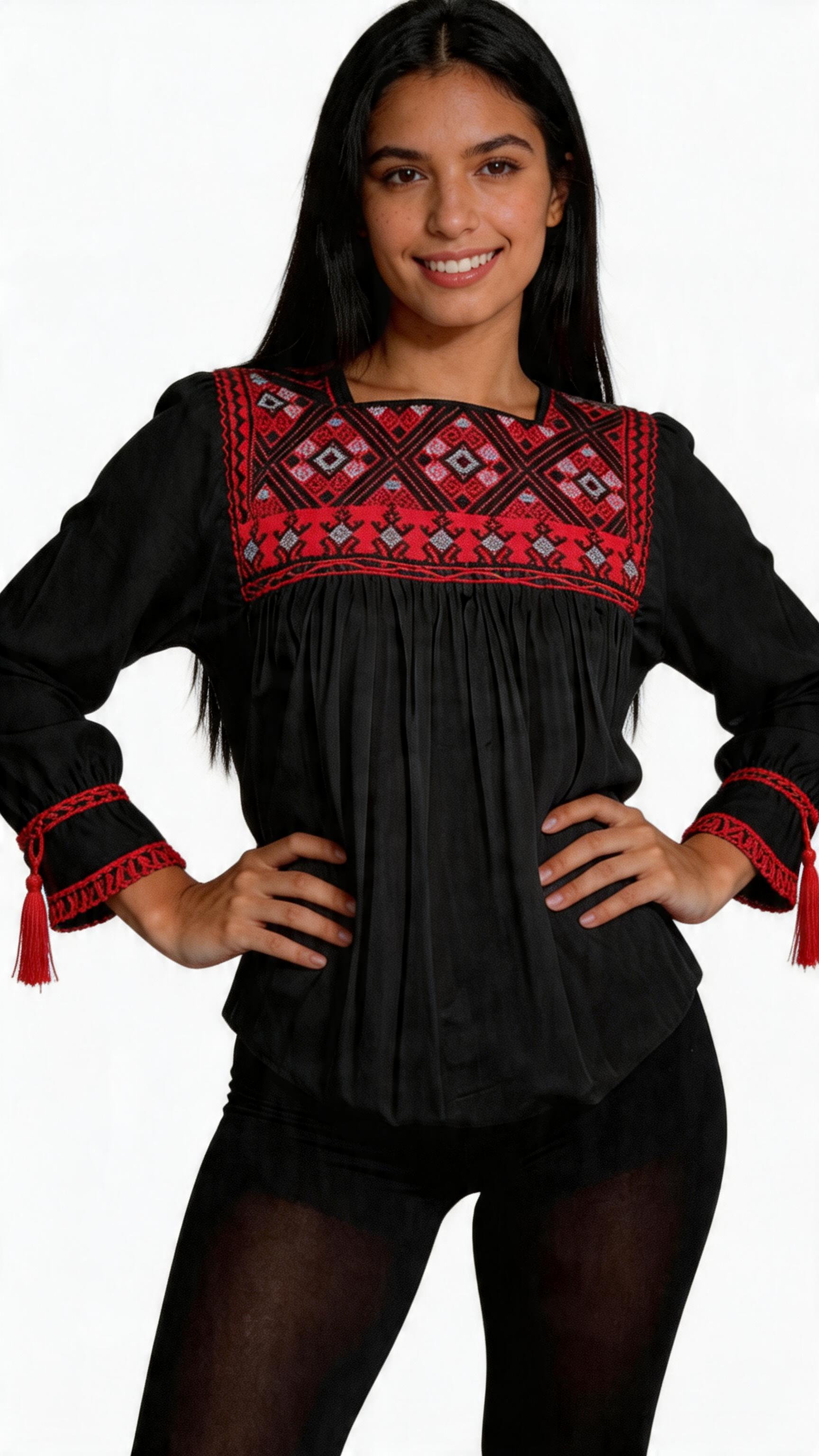 Woman wearing a black dress with red embroidered details, standing with hands on hips, smiling, against a white background.