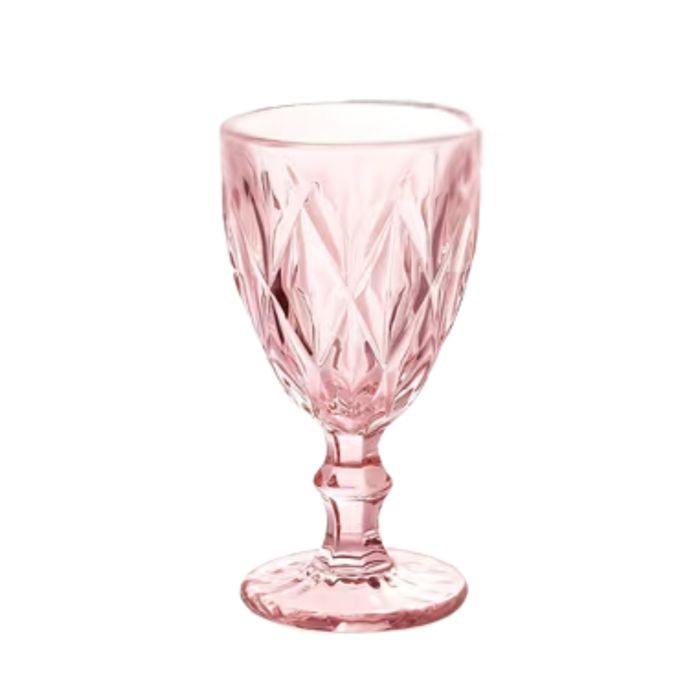 A pink, cut-glass goblet with a decorative diamond pattern