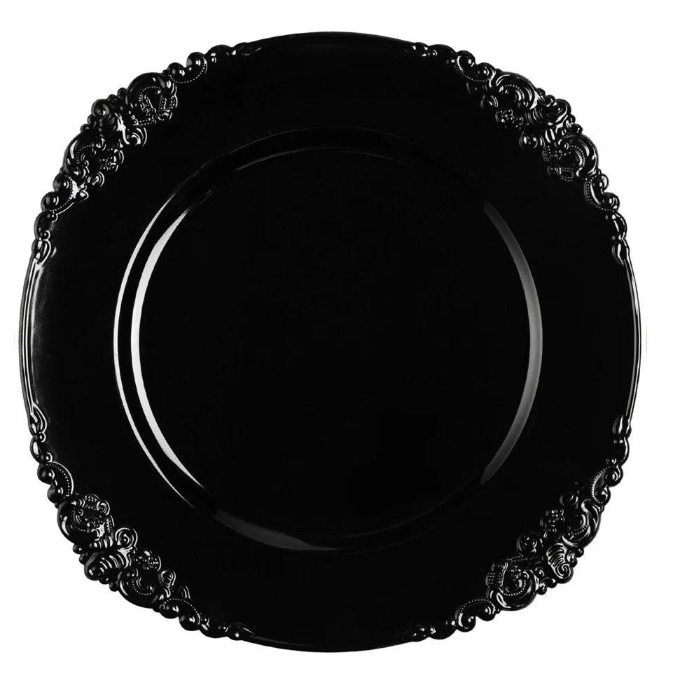 A glossy black decorative plate with an ornate, intricate border design.