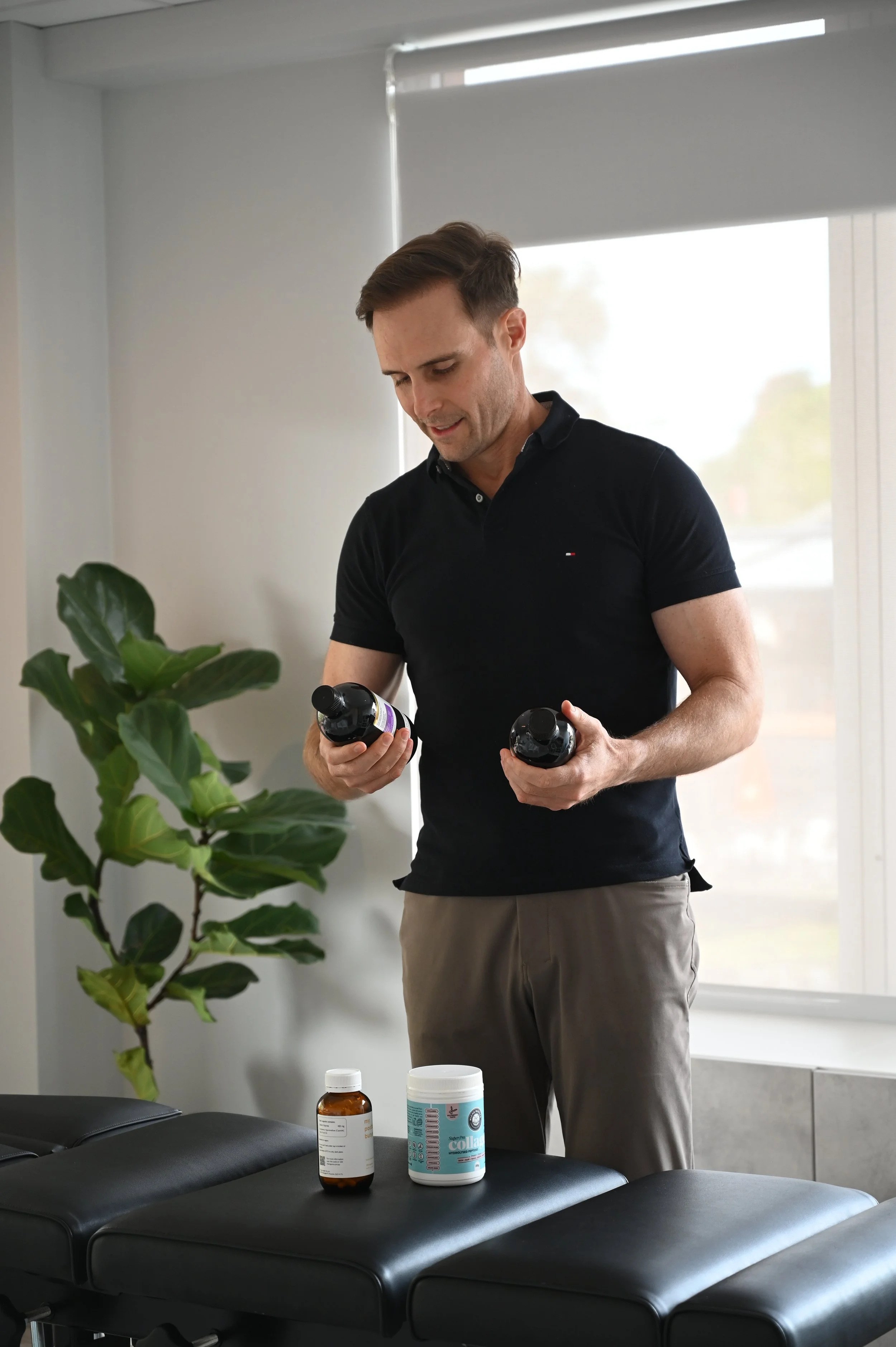 Dr Matt le Roux functional medicine practitioner Gold Coast reviewing supplement protocol at Wave Functional Health Robina