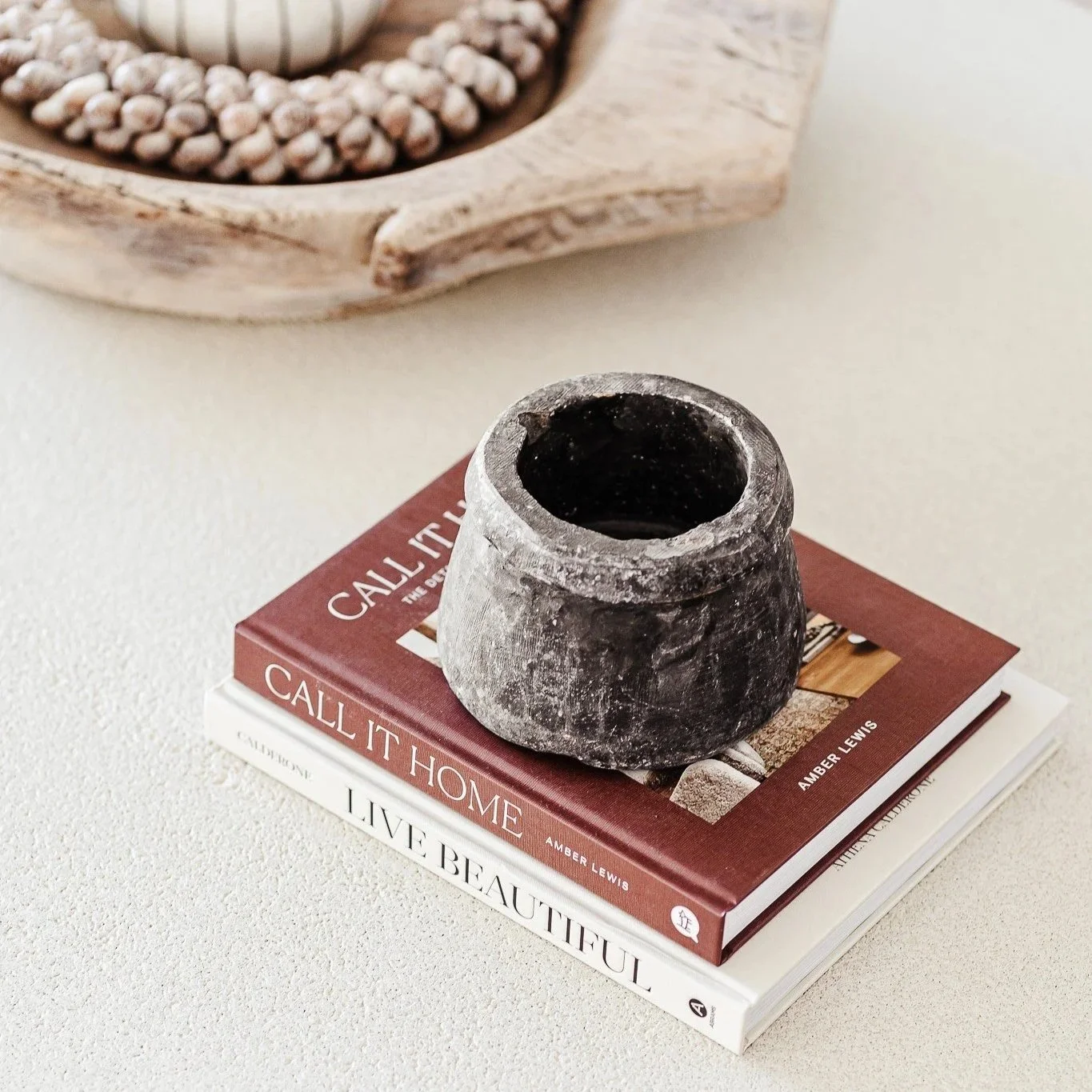 Coffee table styling with stone mortar and design books by Terra Styling — South Coast NSW