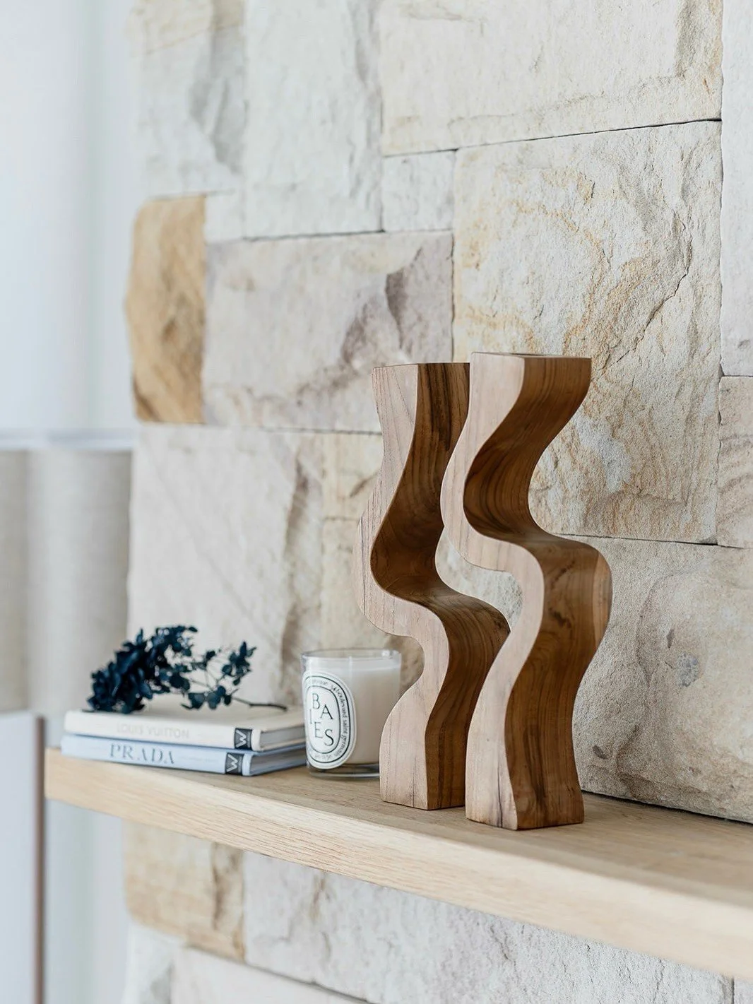Shelf styling with wooden sculptures, candle, and dried flowers by Terra Styling — South Coast NSW