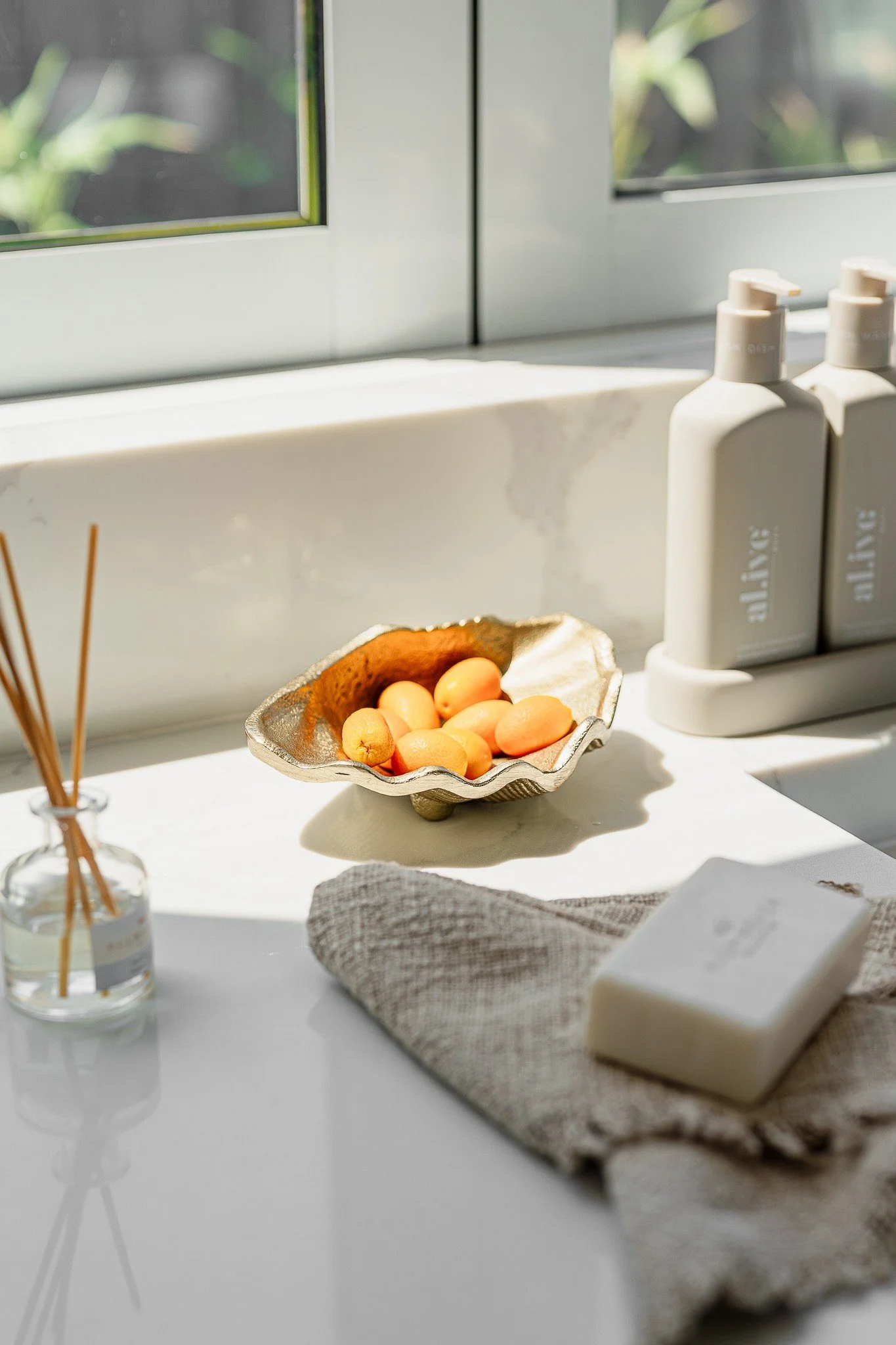 Windowsill detail with peaches and natural products styled by Terra Styling — coastal home