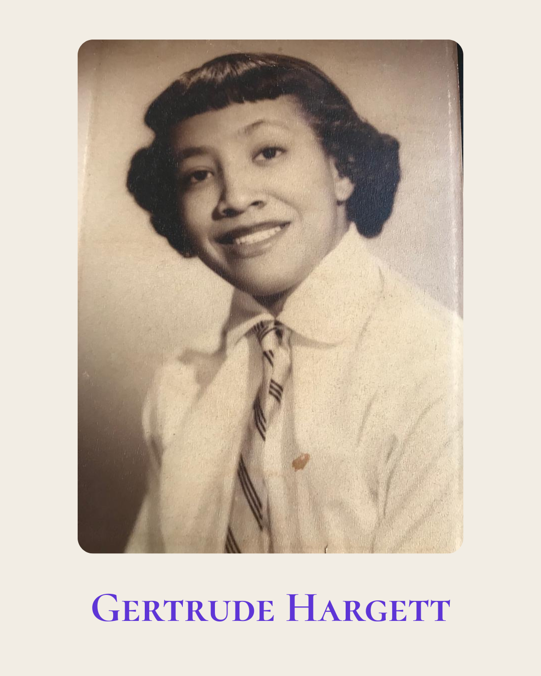 Vintage, black and white portrait of Gertrude Hargett smiling and wearing a collared shirt and tie.