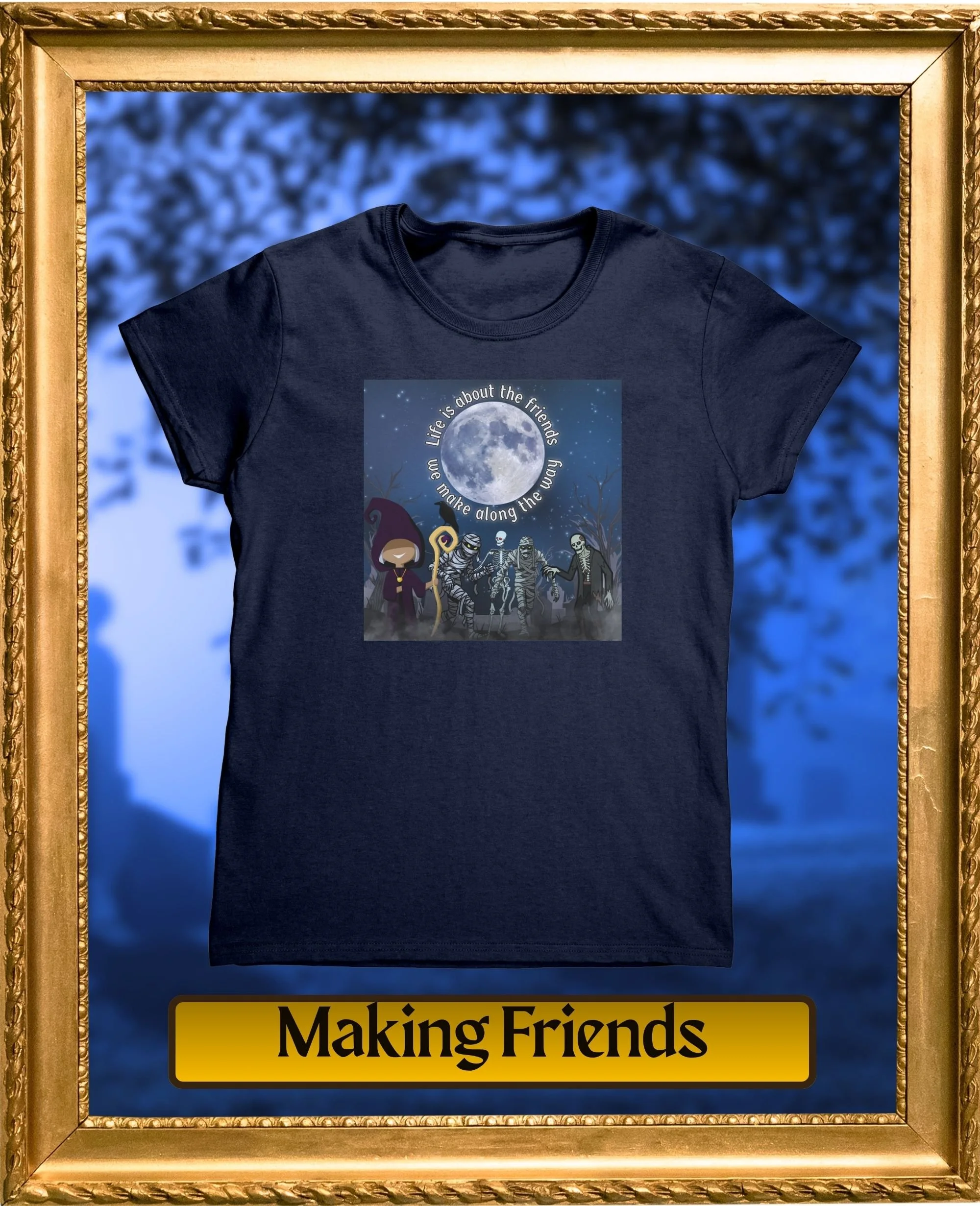 A black T-shirt featuring a moon with the phrase "Life is about the friends we make along the way" written in a circle around the moon. The T-shirt is framed in a gold ornate frame with a blurred blue background.